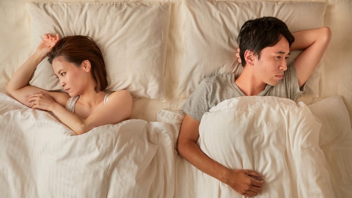 Couple disconnected in bed