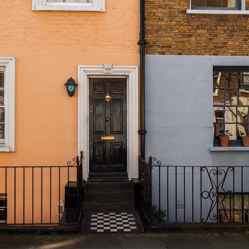 front door of an orange refurbished home in islington