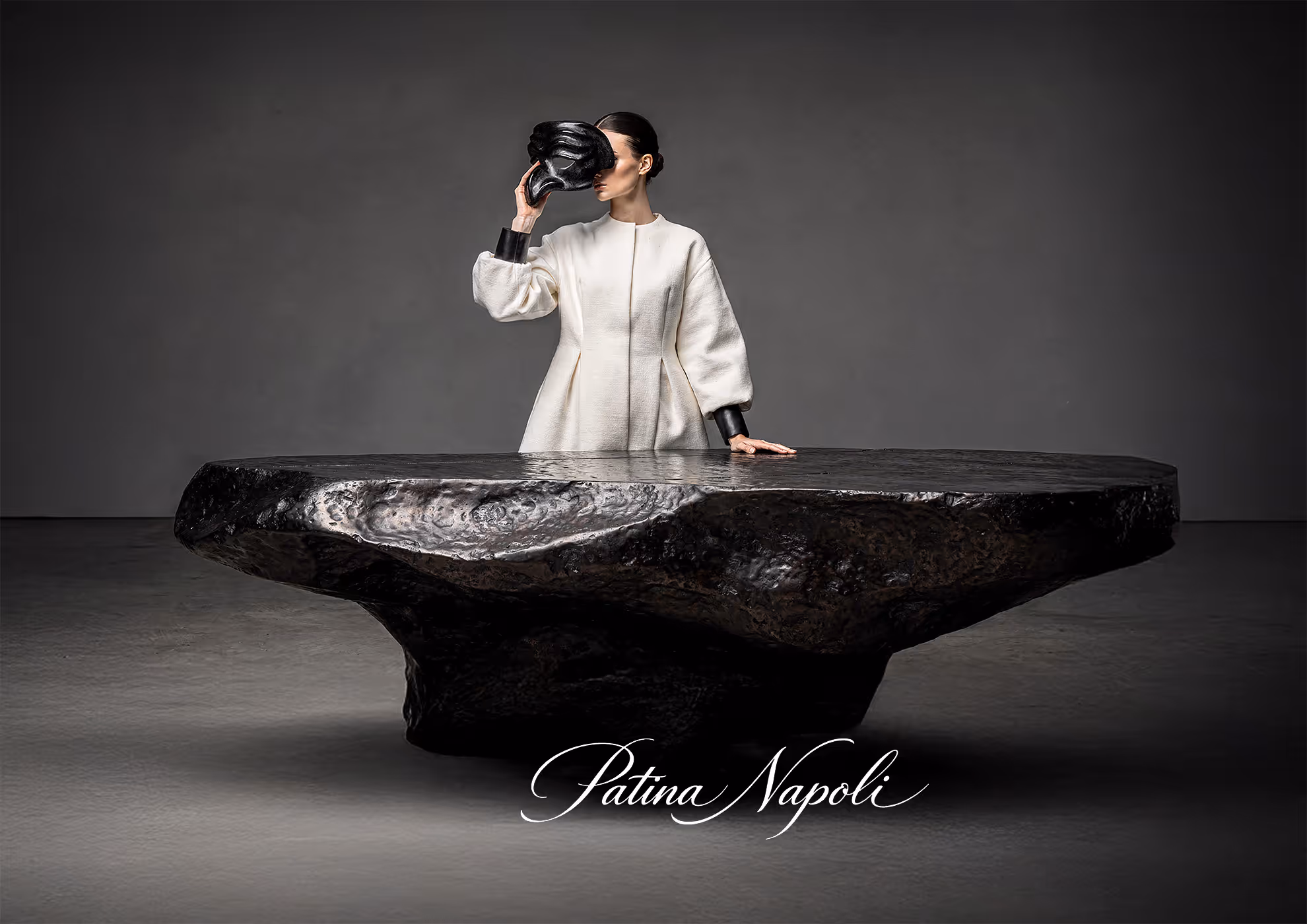 Brunished real iron table with Patina Napoli finish by Molteni Vernici, handcrafted metal surface treated with author’s patinas for deep black iron oxidation effect in luxury interior design setting.