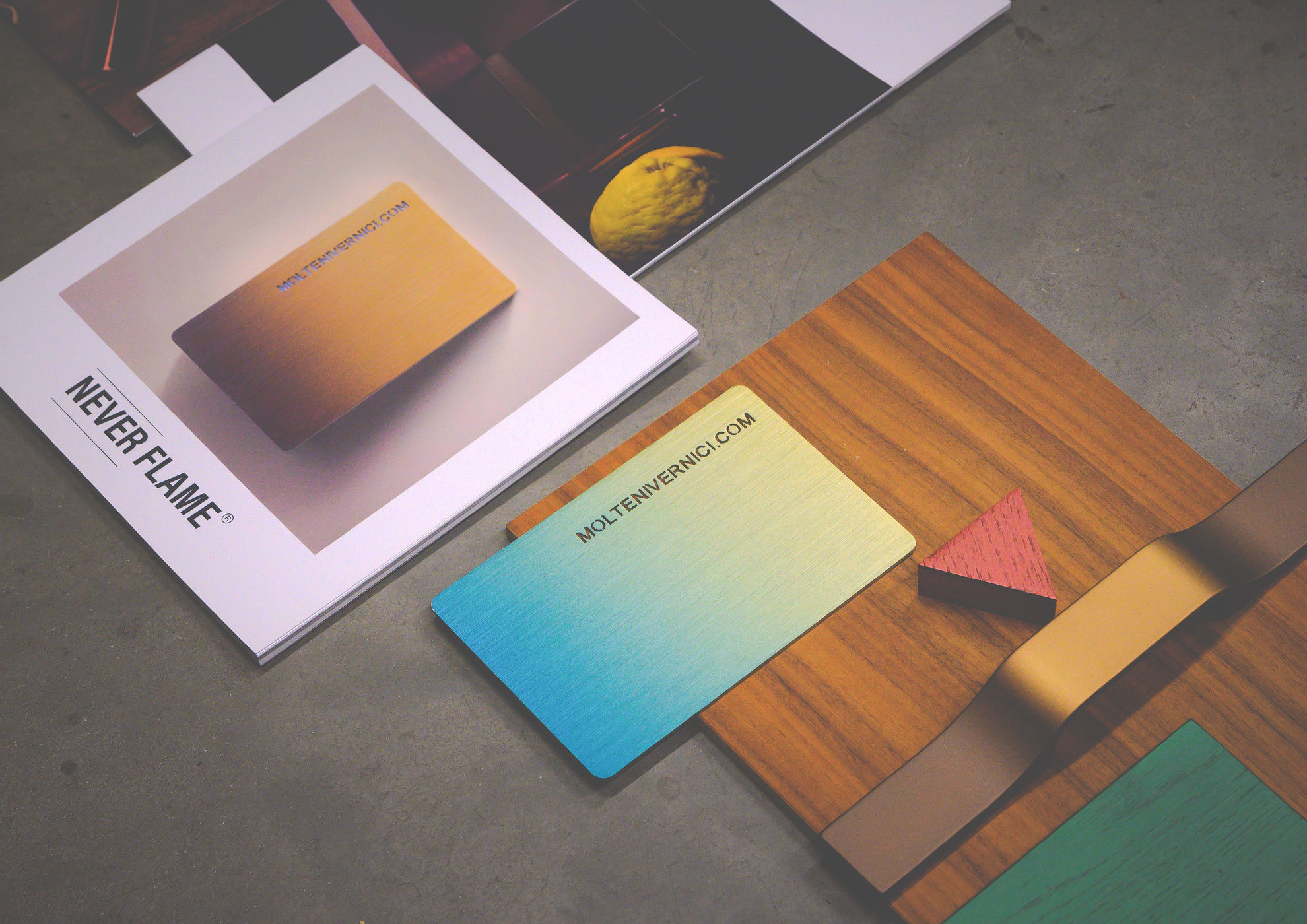 Colorful gradient cards, magazine, and wooden surface with lemon