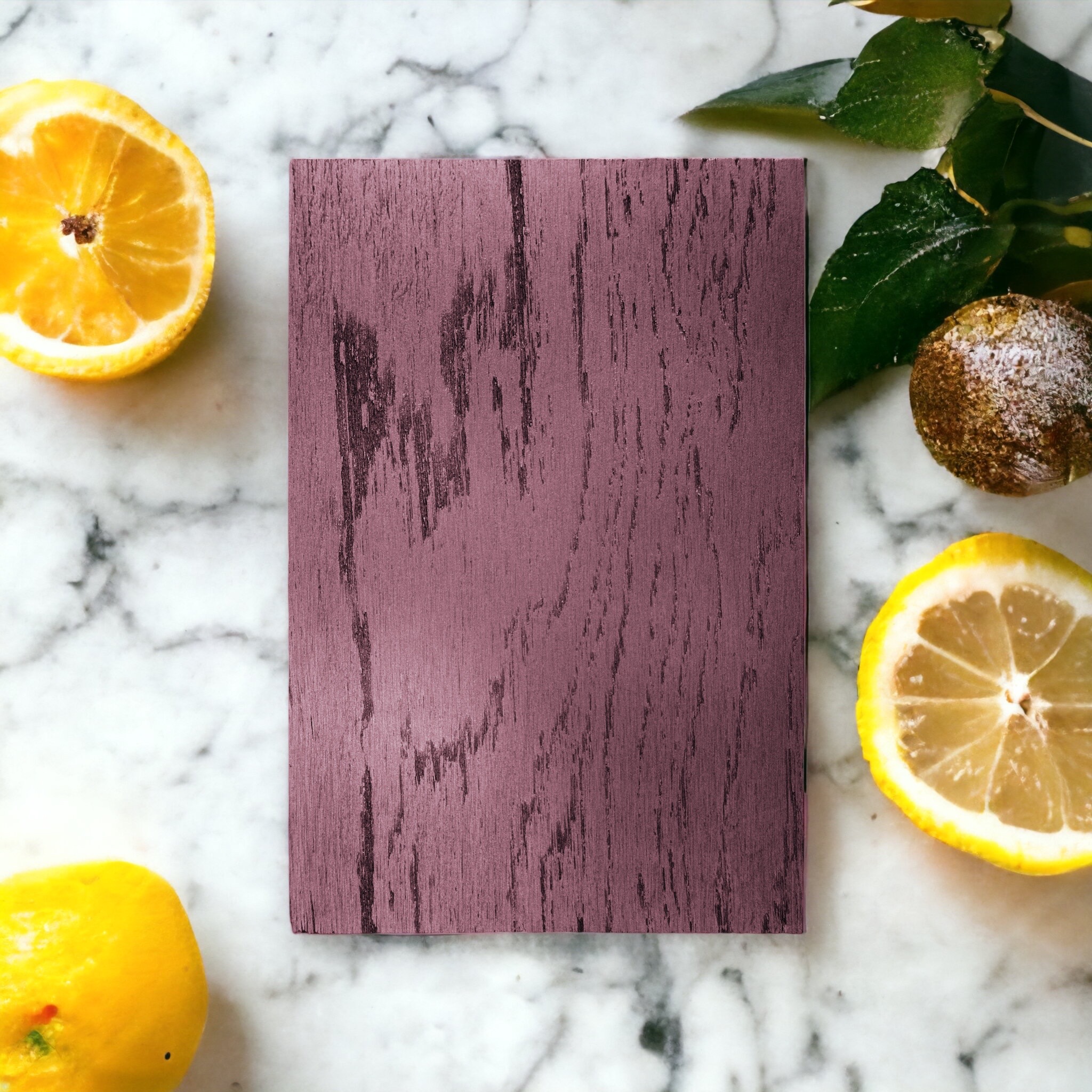 Citrons jaunes et tableau en bois rose sur fond de marbre