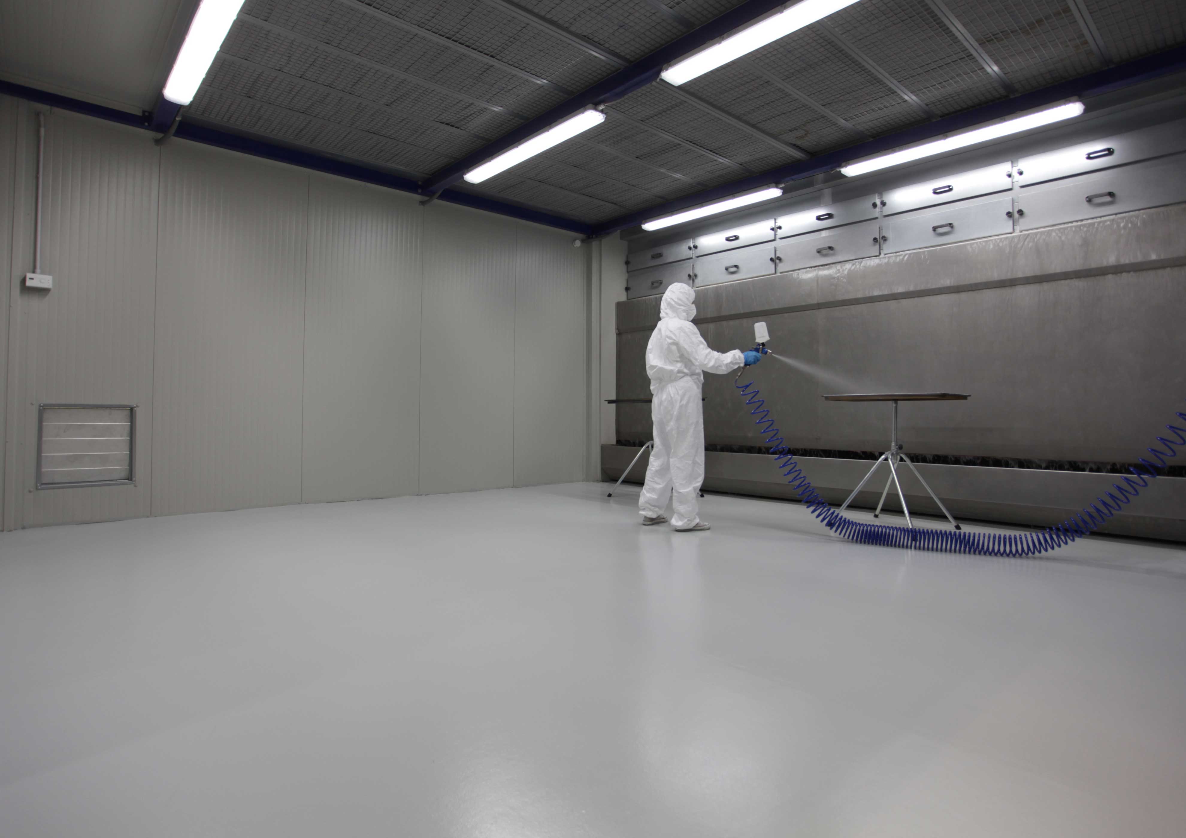 Pinturas especiales MOLTENI-VERNICI: técnico en traje blanco aplicando acabados