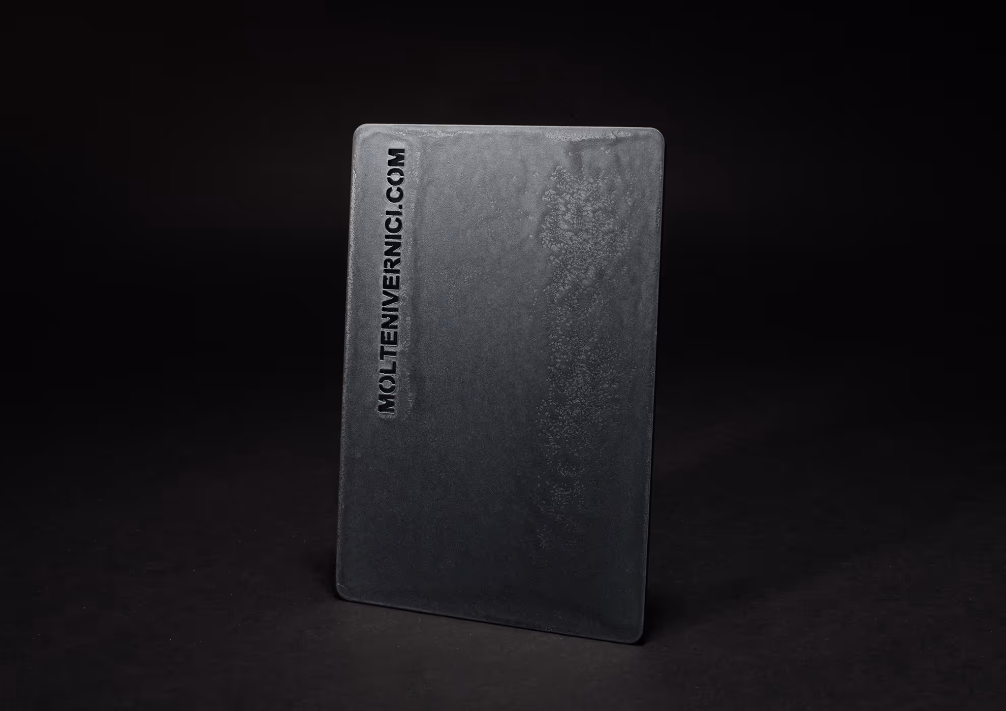 Muestra de acabados MOLTENI-VERNICI en placa metálica gris oscura