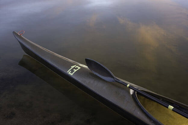 MOLTENI-VERNICI Special Primer kayak on misty water with reflective surface