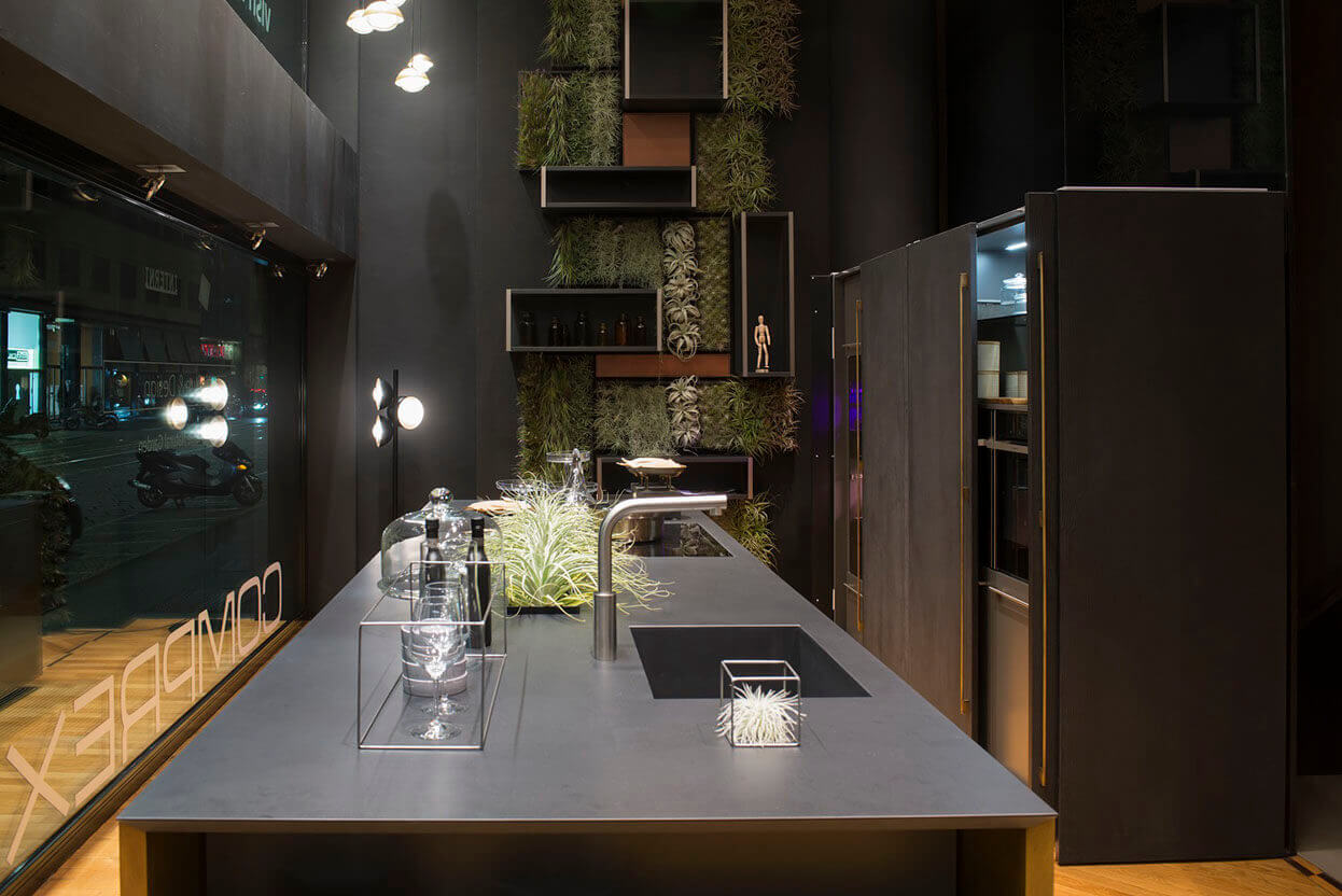 MOLTENI-VERNICI showroom with special paint effects, dark kitchen design with plants