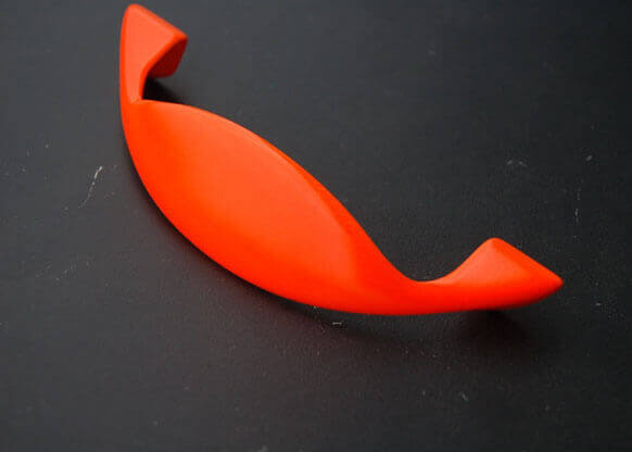 MOLTENI-VERNICI fluo paint curved orange object against dark background