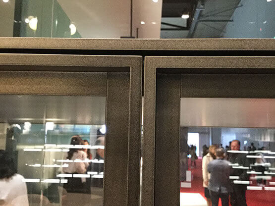 MOLTENI-VERNICI: Vintage bronzed brass paint effect on reflective glass cabinets