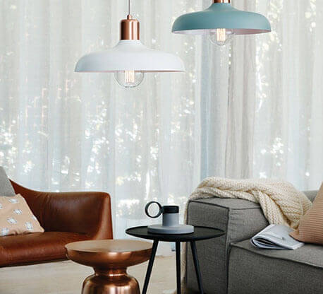 MOLTENI-VERNICI copper paint effect pendant lamps illuminate cozy living space