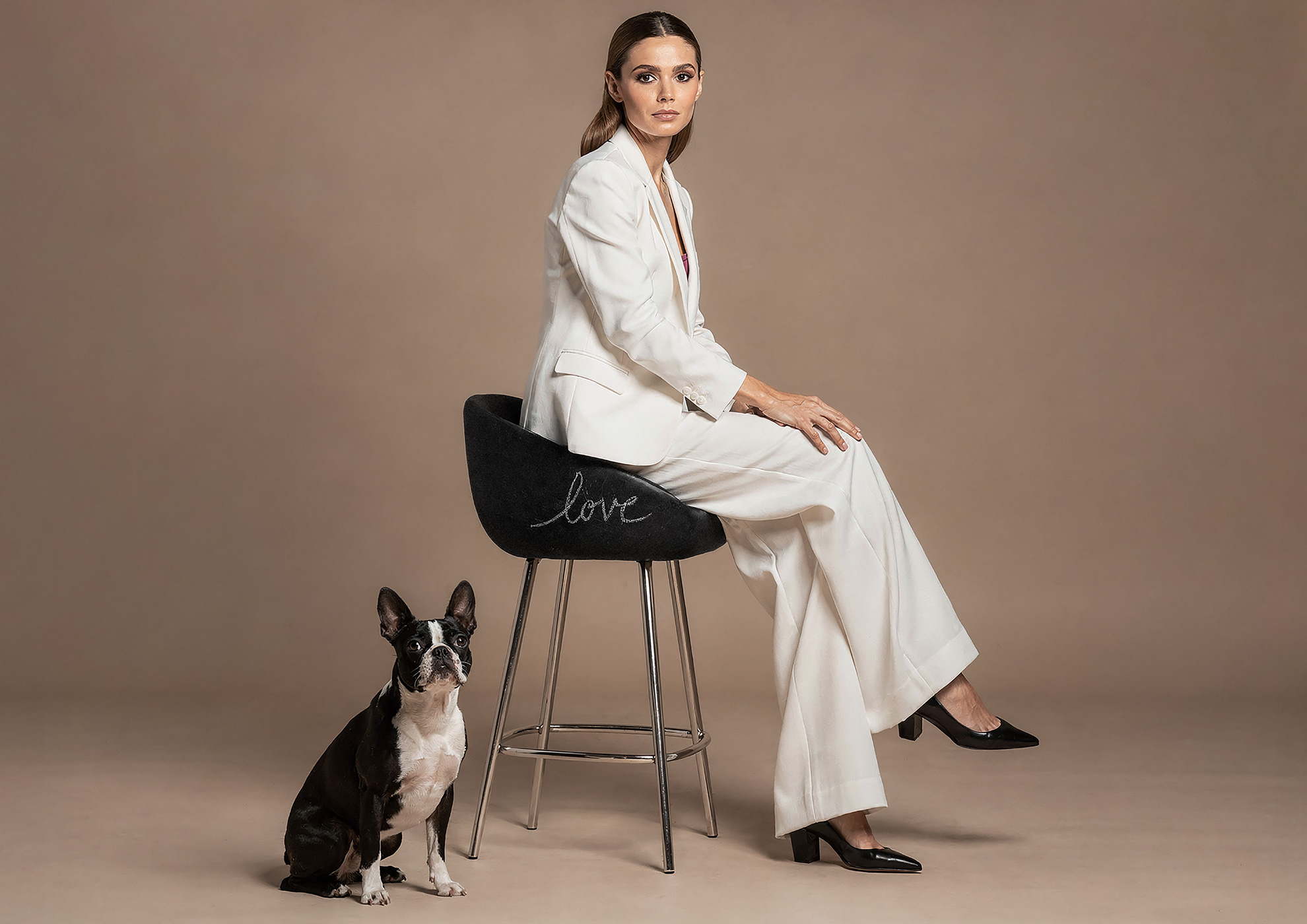 Minimalist architectural scene with a woman in a black couture dress standing on a reflective surface, expressing Molteni Vernici’s approach to special paints, advanced surface technologies, and design-driven material innovation.