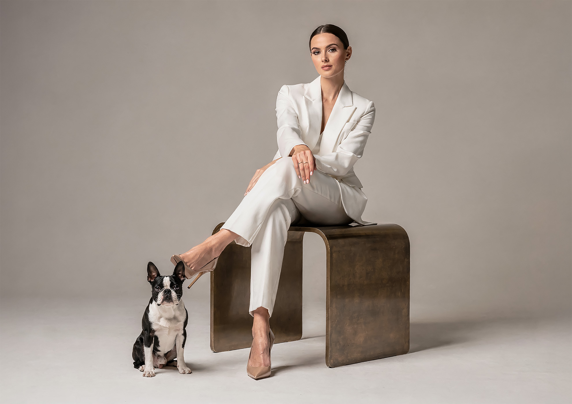 Minimalist architectural scene with a woman in a black couture dress standing on a reflective surface, expressing Molteni Vernici’s approach to special paints, advanced surface technologies, and design-driven material innovation.