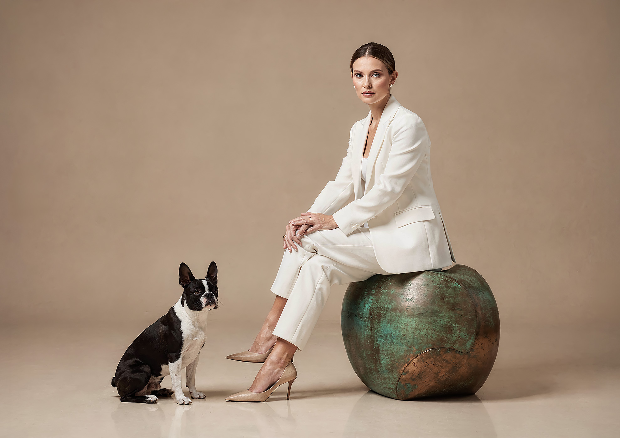 Minimalist architectural scene with a woman in a black couture dress standing on a reflective surface, expressing Molteni Vernici’s approach to special paints, advanced surface technologies, and design-driven material innovation.