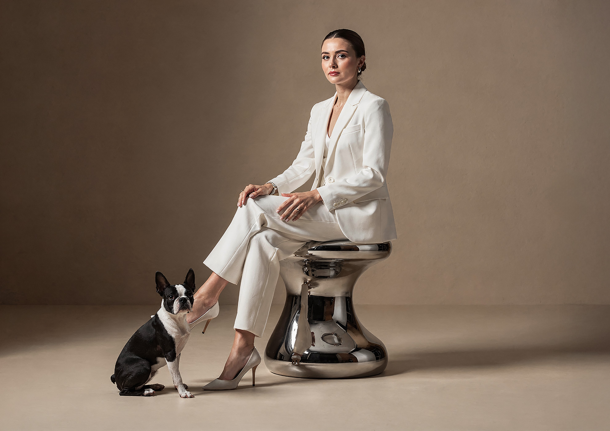 Minimalist architectural scene with a woman in a black couture dress standing on a reflective surface, expressing Molteni Vernici’s approach to special paints, advanced surface technologies, and design-driven material innovation.