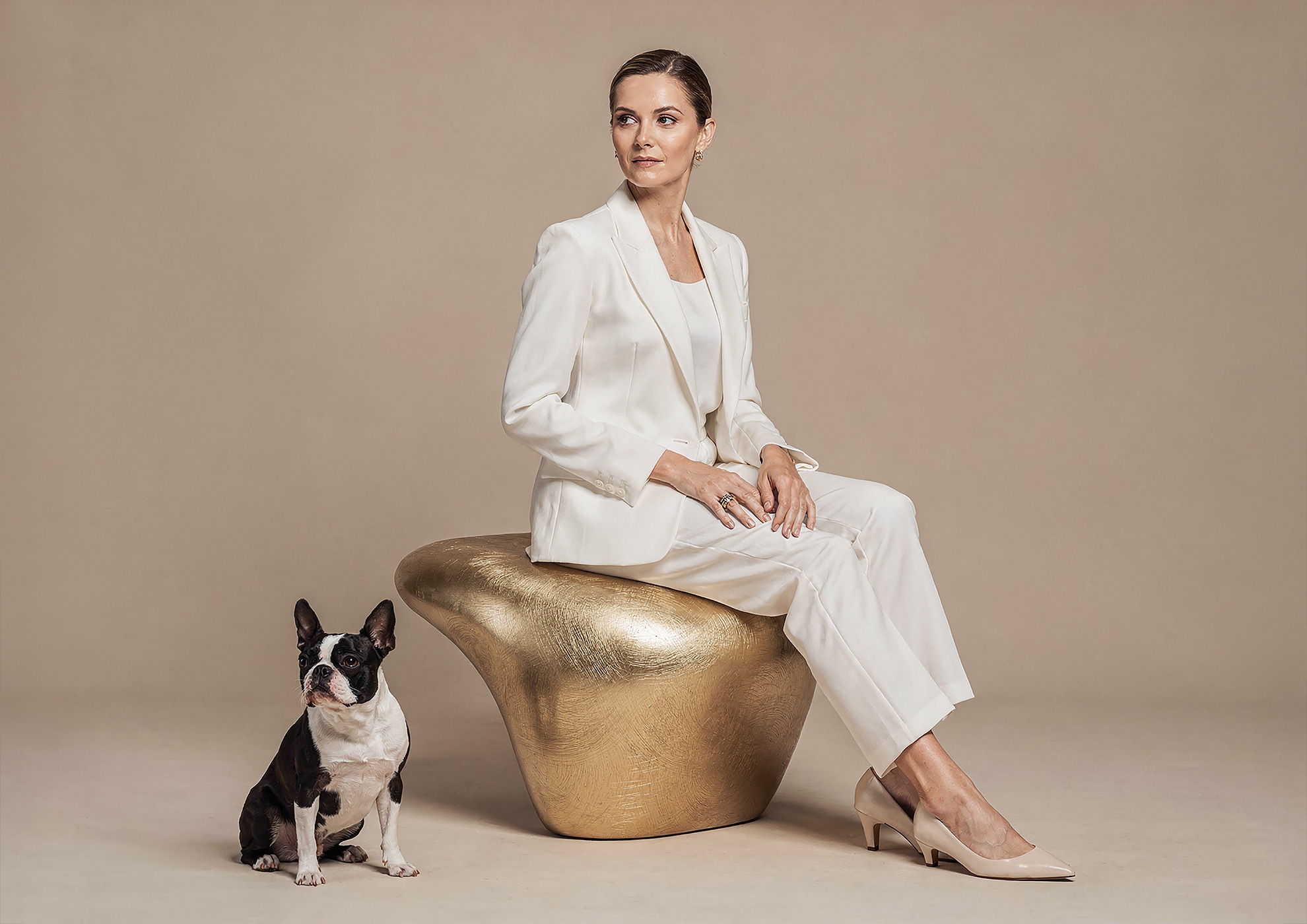 Minimalist architectural scene with a woman in a black couture dress standing on a reflective surface, expressing Molteni Vernici’s approach to special paints, advanced surface technologies, and design-driven material innovation.
