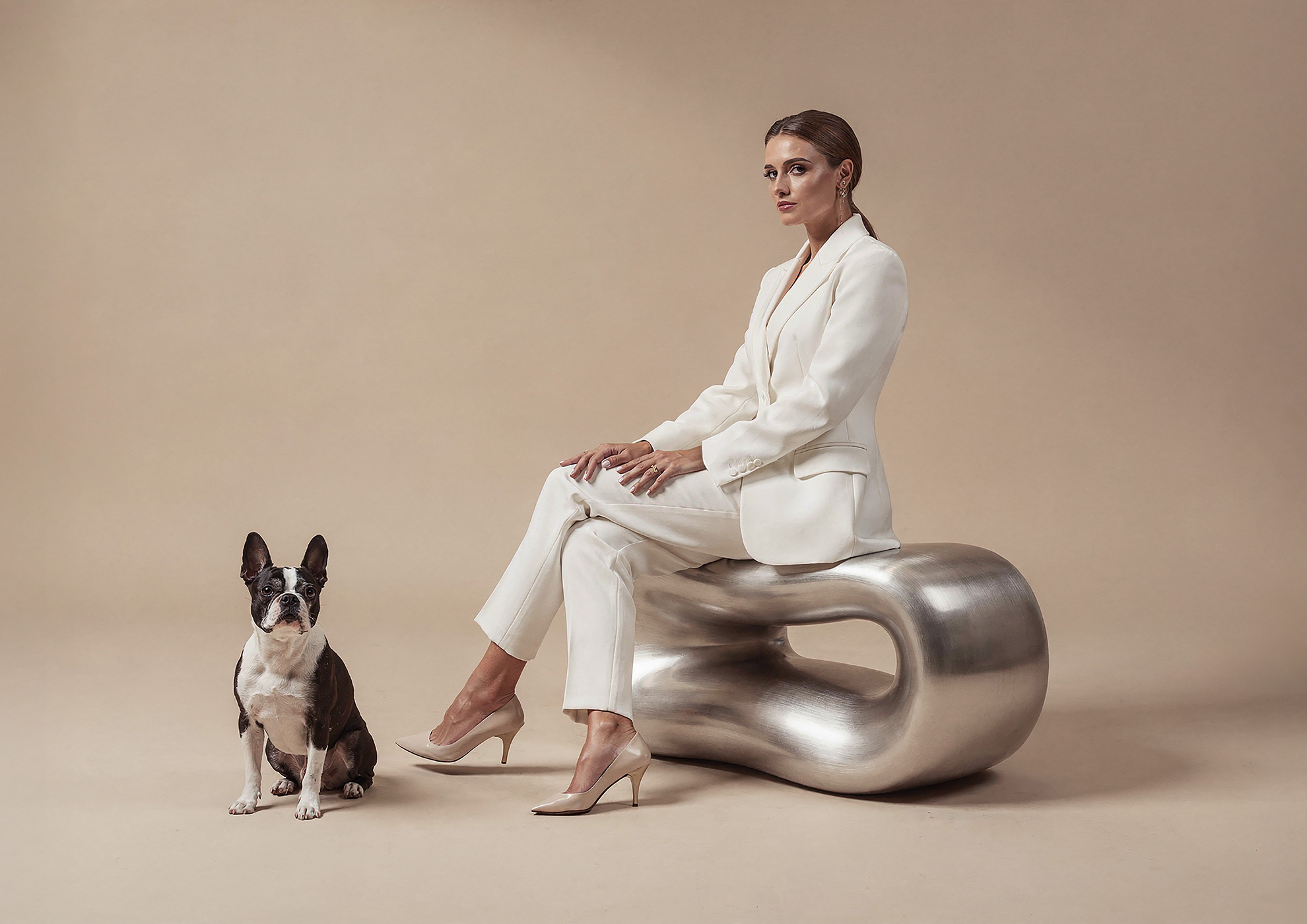 Minimalist architectural scene with a woman in a black couture dress standing on a reflective surface, expressing Molteni Vernici’s approach to special paints, advanced surface technologies, and design-driven material innovation.
