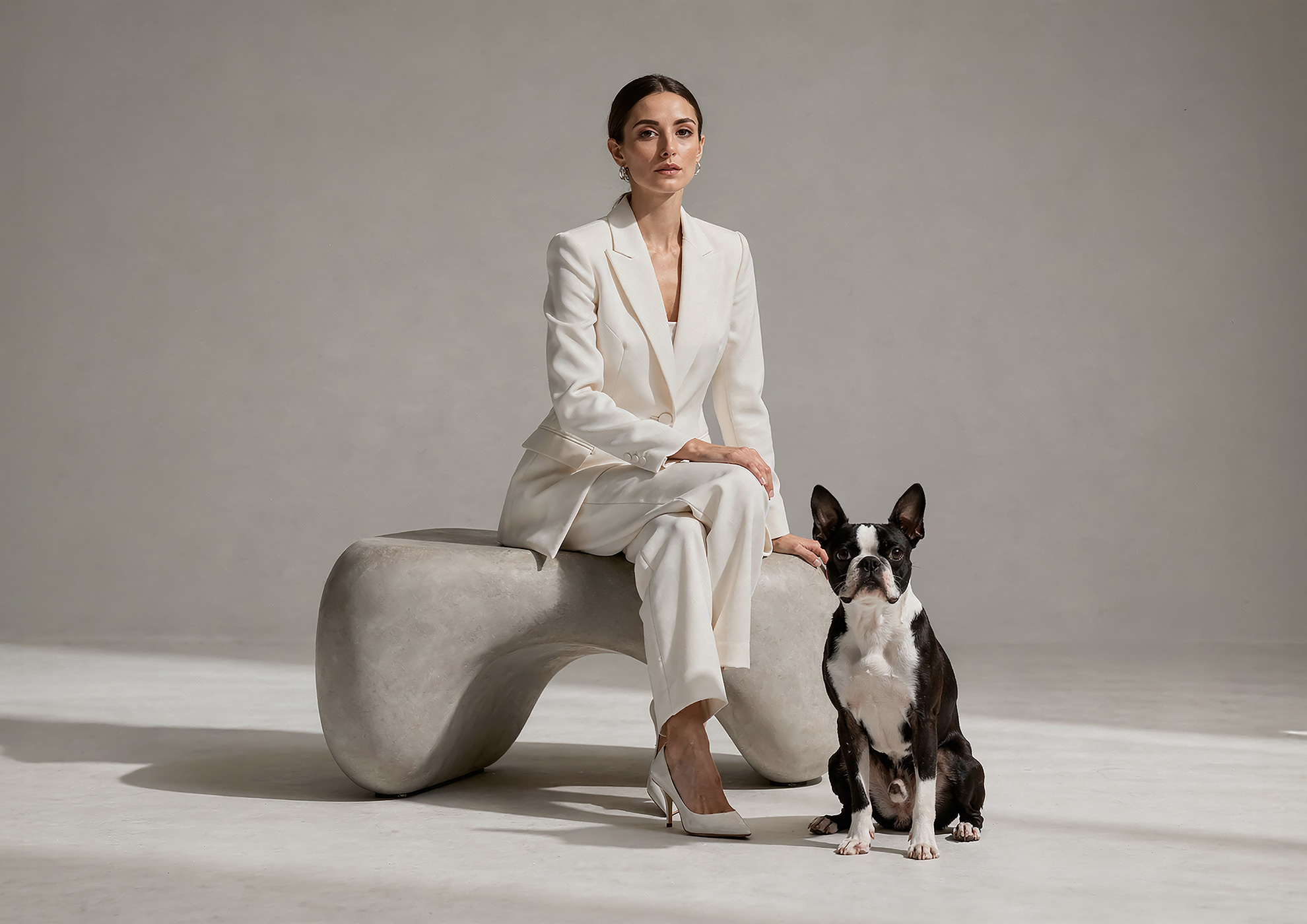 Minimalist architectural scene with a woman in a black couture dress standing on a reflective surface, expressing Molteni Vernici’s approach to special paints, advanced surface technologies, and design-driven material innovation.