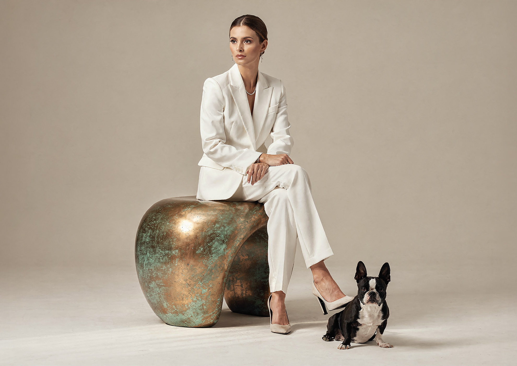 Minimalist architectural scene with a woman in a black couture dress standing on a reflective surface, expressing Molteni Vernici’s approach to special paints, advanced surface technologies, and design-driven material innovation.