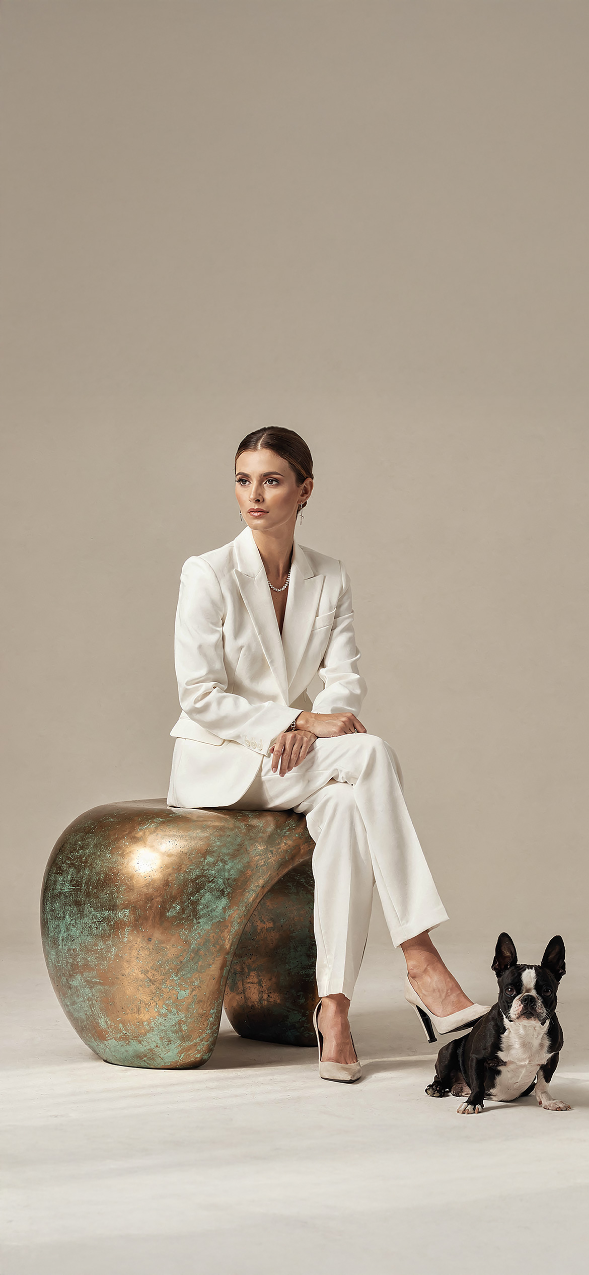 Luxury architectural metal finish by Molteni Vernici applied on a sculptural brass table surface in a contemporary interior.