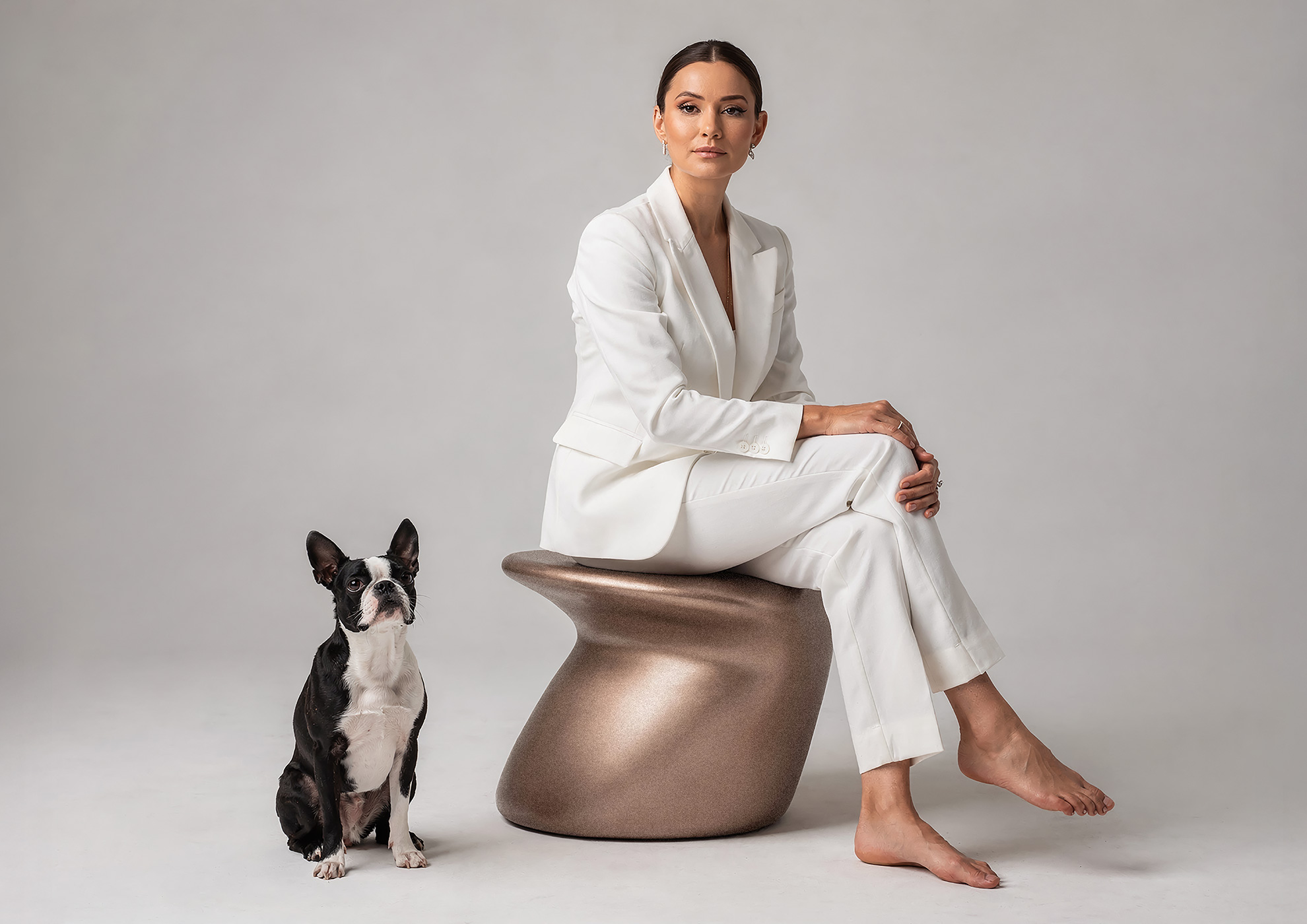 Minimalist architectural scene with a woman in a black couture dress standing on a reflective surface, expressing Molteni Vernici’s approach to special paints, advanced surface technologies, and design-driven material innovation.
