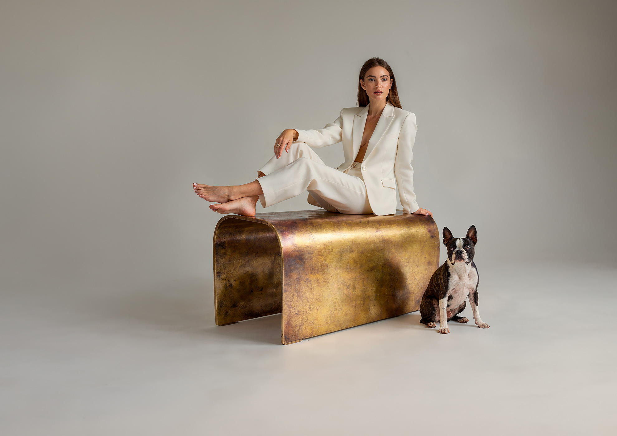 Minimalist architectural scene with a woman in a black couture dress standing on a reflective surface, expressing Molteni Vernici’s approach to special paints, advanced surface technologies, and design-driven material innovation.