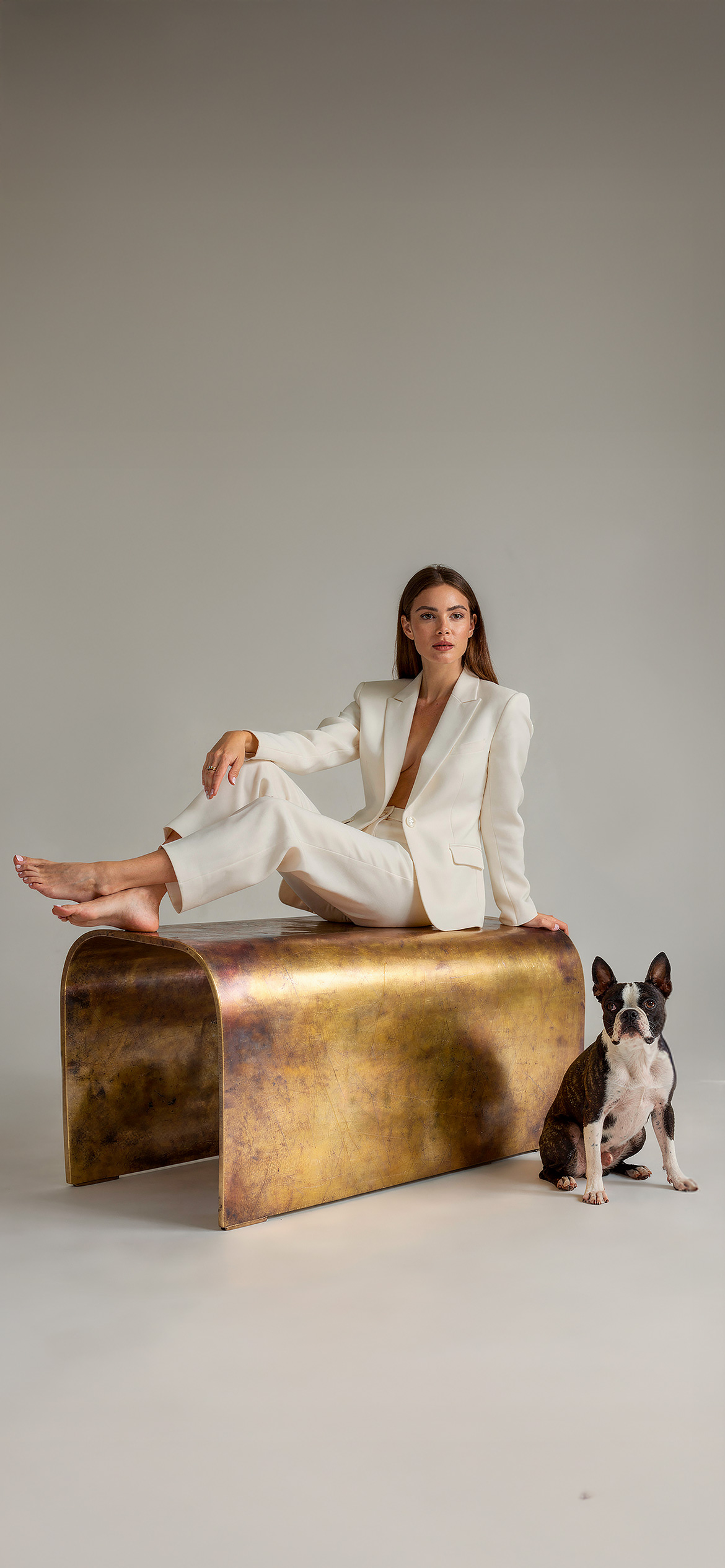 Luxury architectural metal finish by Molteni Vernici applied on a sculptural brass table surface in a contemporary interior.