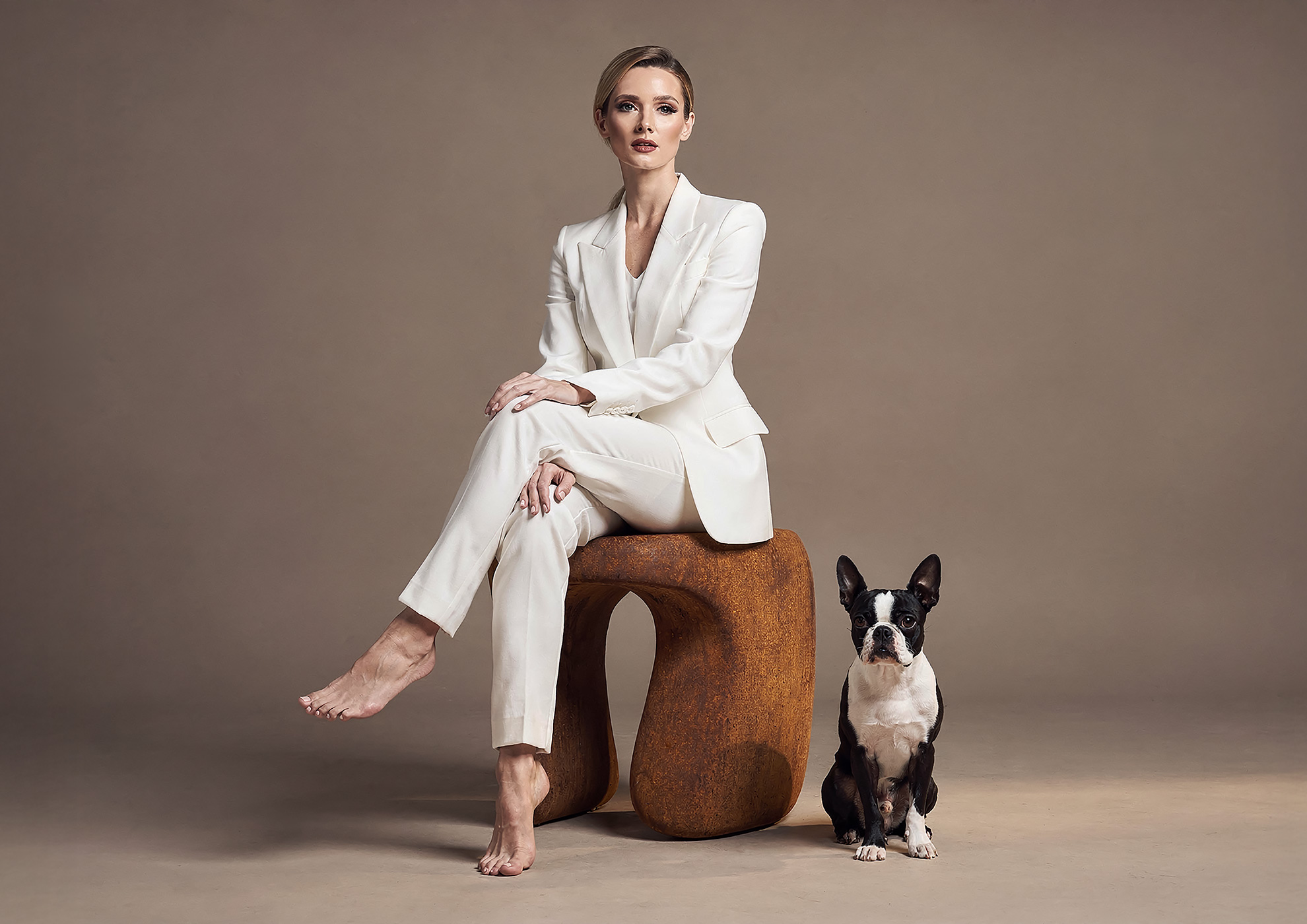 Minimalist architectural scene with a woman in a black couture dress standing on a reflective surface, expressing Molteni Vernici’s approach to special paints, advanced surface technologies, and design-driven material innovation.