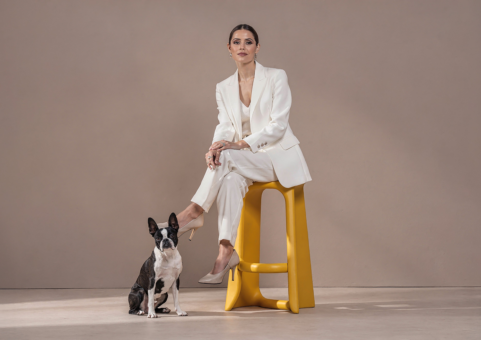 Minimalist architectural scene with a woman in a black couture dress standing on a reflective surface, expressing Molteni Vernici’s approach to special paints, advanced surface technologies, and design-driven material innovation.