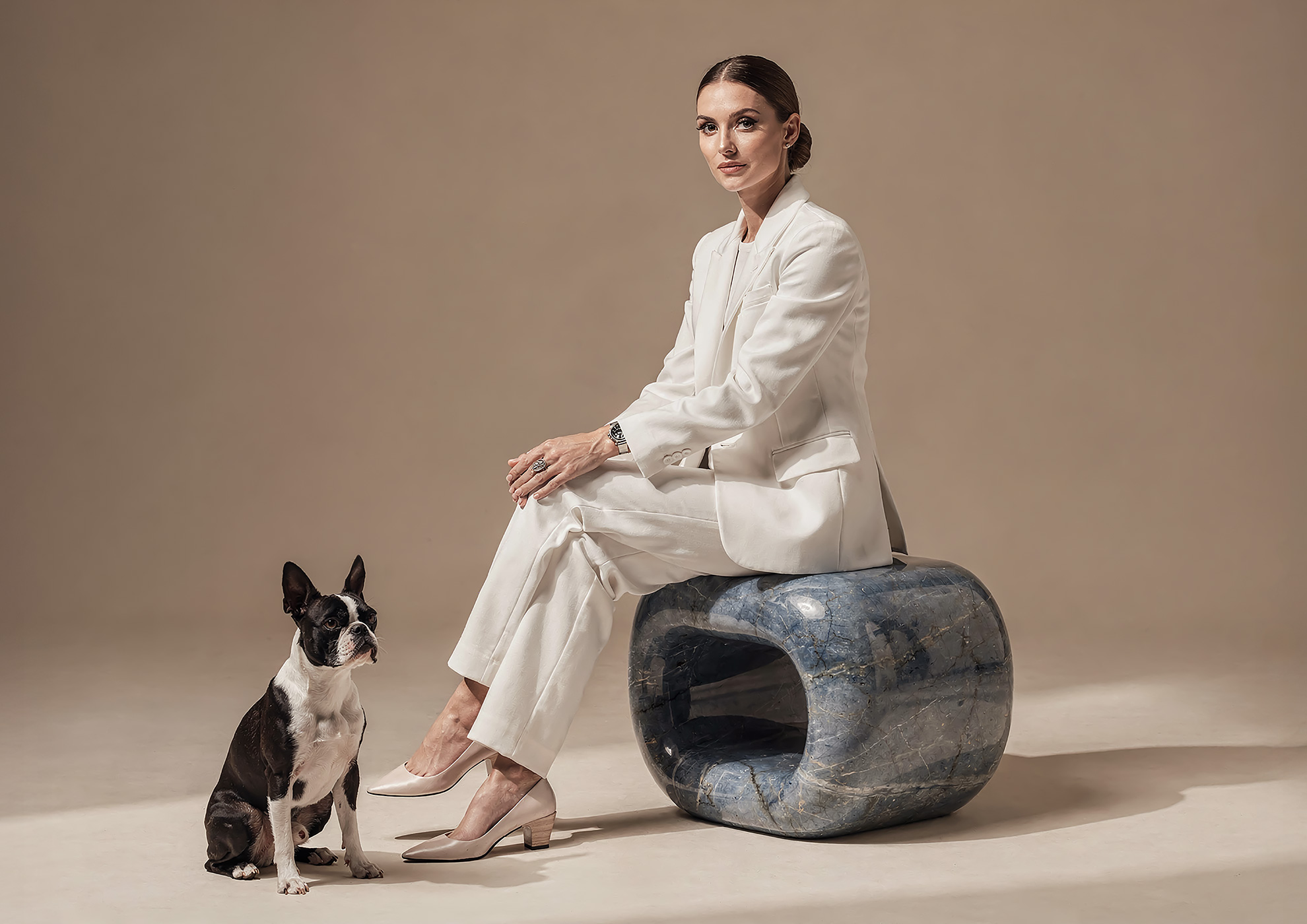 Minimalist architectural scene with a woman in a black couture dress standing on a reflective surface, expressing Molteni Vernici’s approach to special paints, advanced surface technologies, and design-driven material innovation.