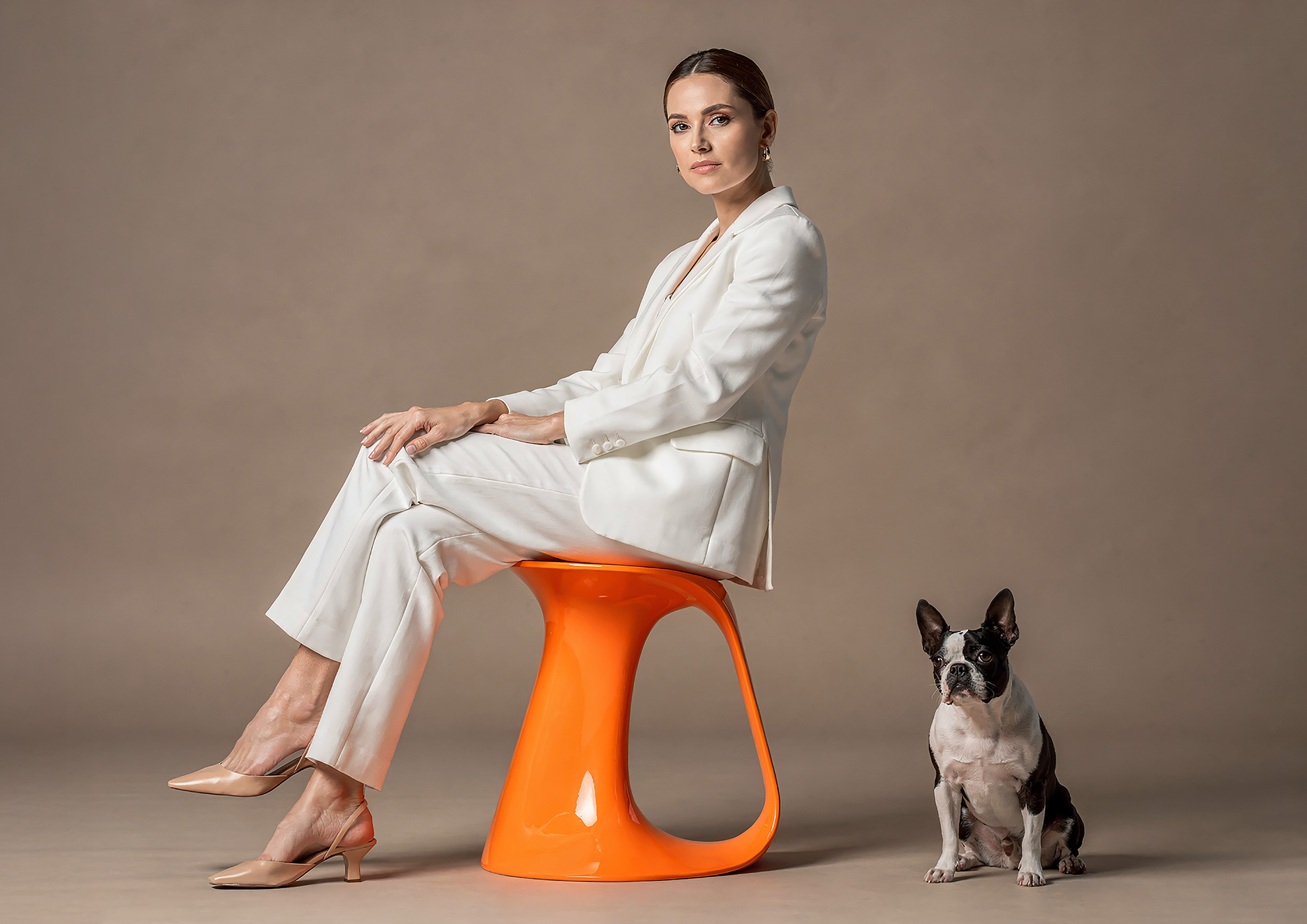 Minimalist architectural scene with a woman in a black couture dress standing on a reflective surface, expressing Molteni Vernici’s approach to special paints, advanced surface technologies, and design-driven material innovation.