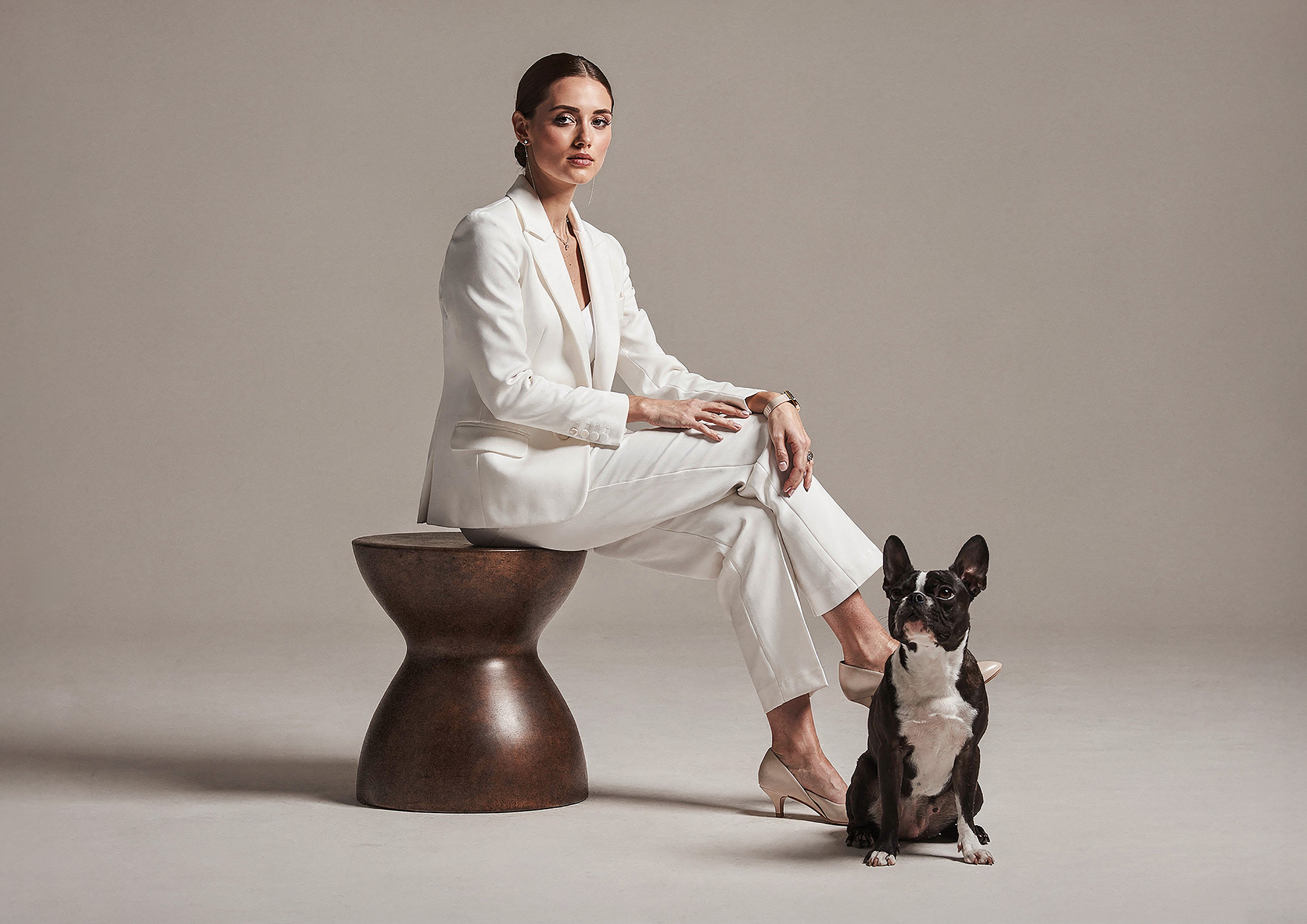 Minimalist architectural scene with a woman in a black couture dress standing on a reflective surface, expressing Molteni Vernici’s approach to special paints, advanced surface technologies, and design-driven material innovation.