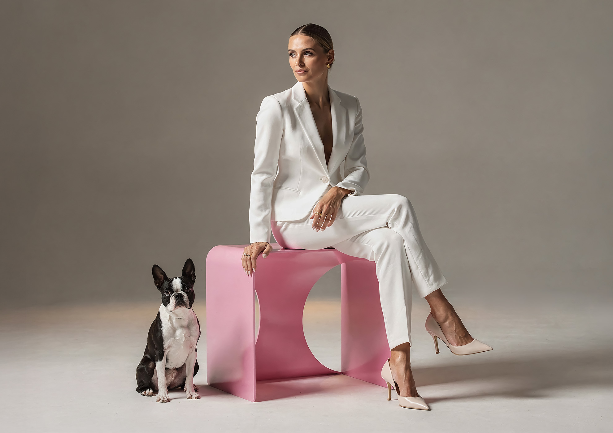 Minimalist architectural scene with a woman in a black couture dress standing on a reflective surface, expressing Molteni Vernici’s approach to special paints, advanced surface technologies, and design-driven material innovation.