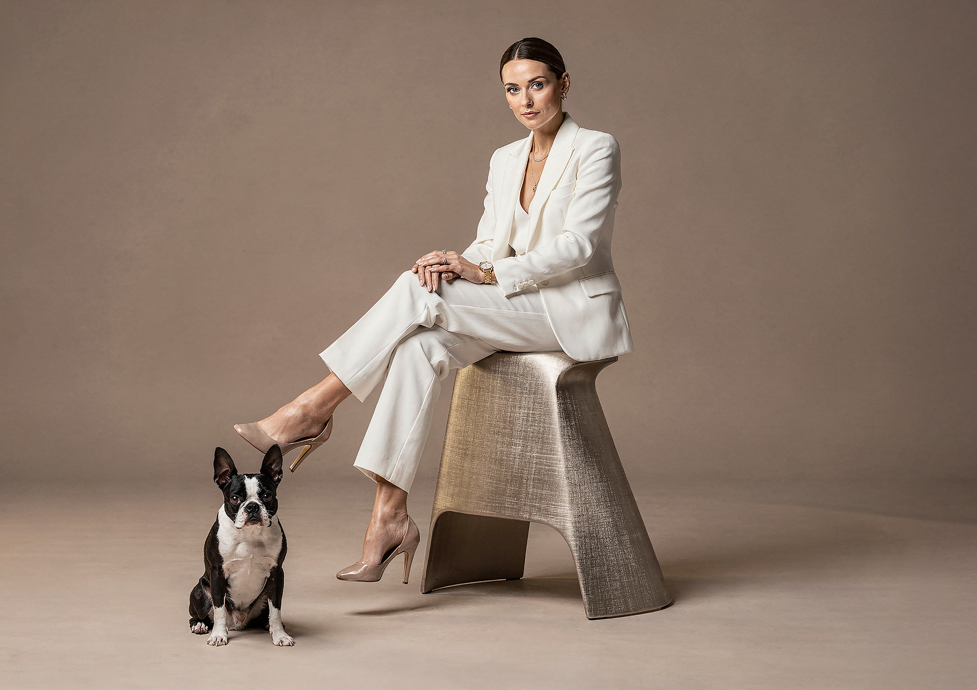 Minimalist architectural scene with a woman in a black couture dress standing on a reflective surface, expressing Molteni Vernici’s approach to special paints, advanced surface technologies, and design-driven material innovation.