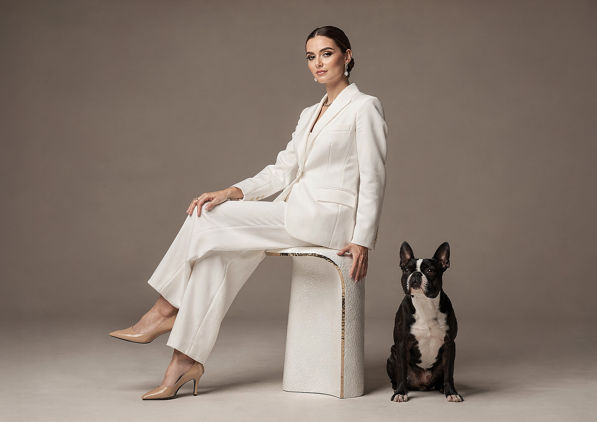 Minimalist architectural scene with a woman in a black couture dress standing on a reflective surface, expressing Molteni Vernici’s approach to special paints, advanced surface technologies, and design-driven material innovation.