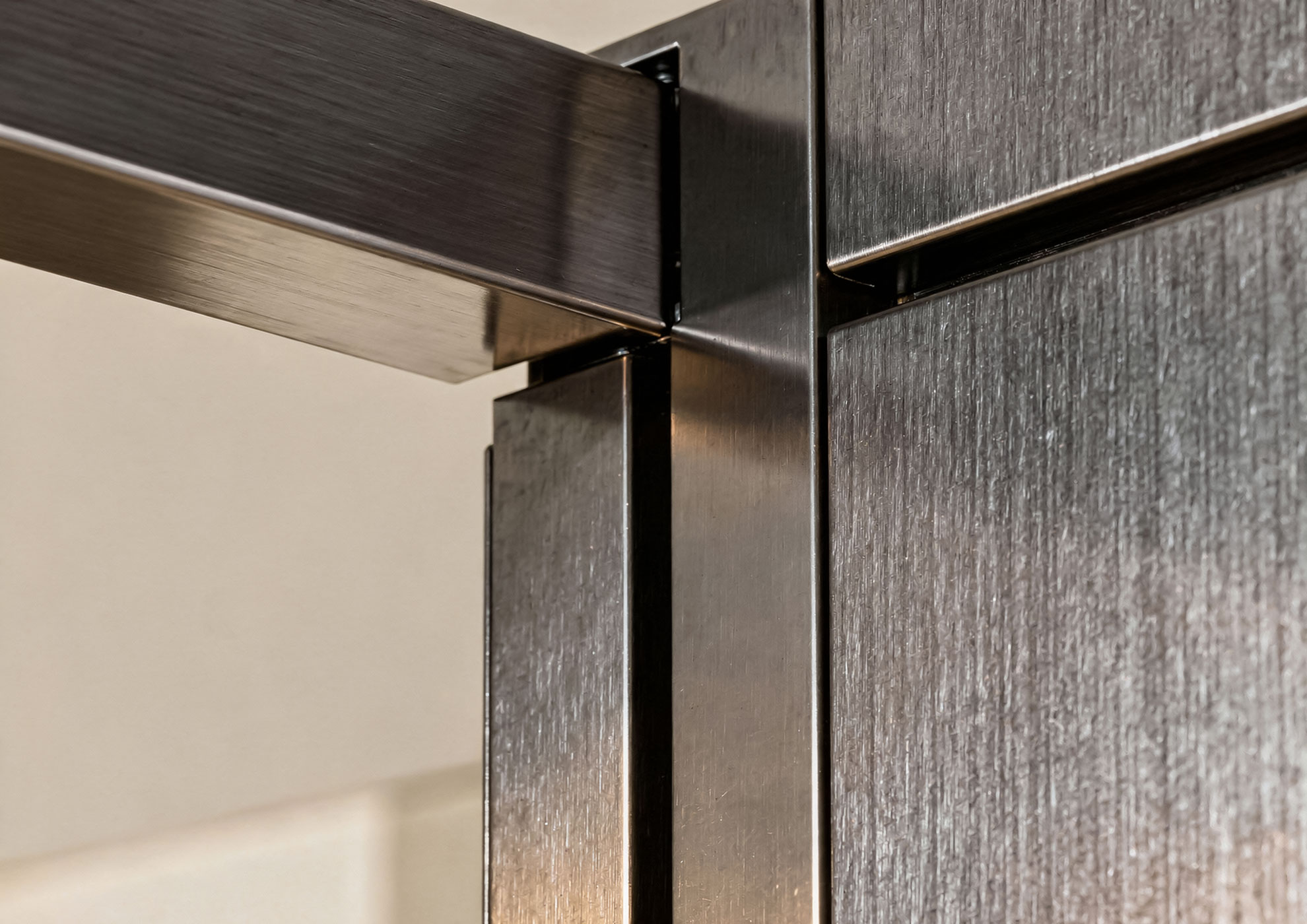 Architectural detail of brushed metal coating with Never Brushed galvanic finish Molteni Vernici, decorative surface with dark effect and premium texture for contemporary luxury interior design.
