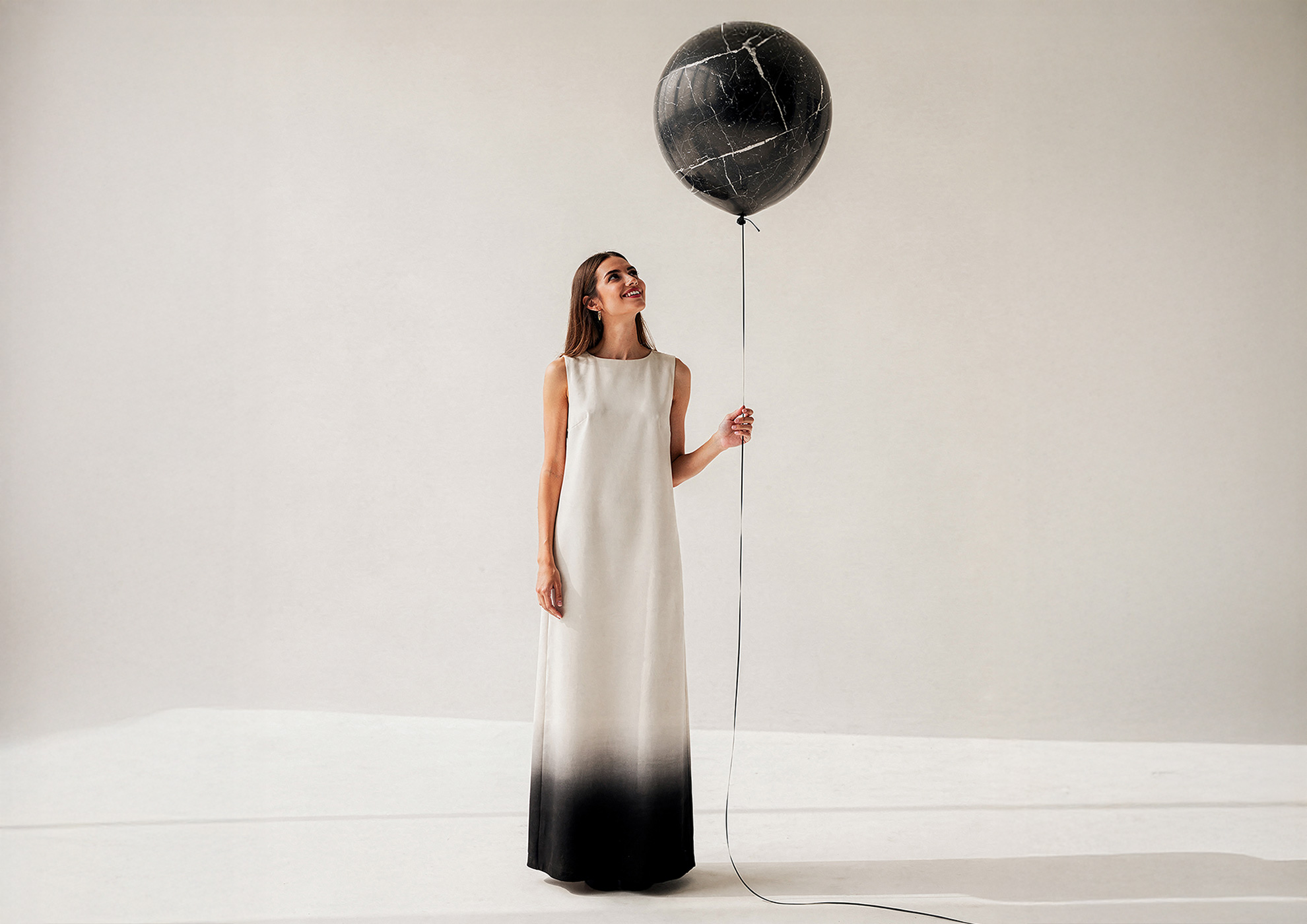 STONAIR floating black marble balloon sculpture.