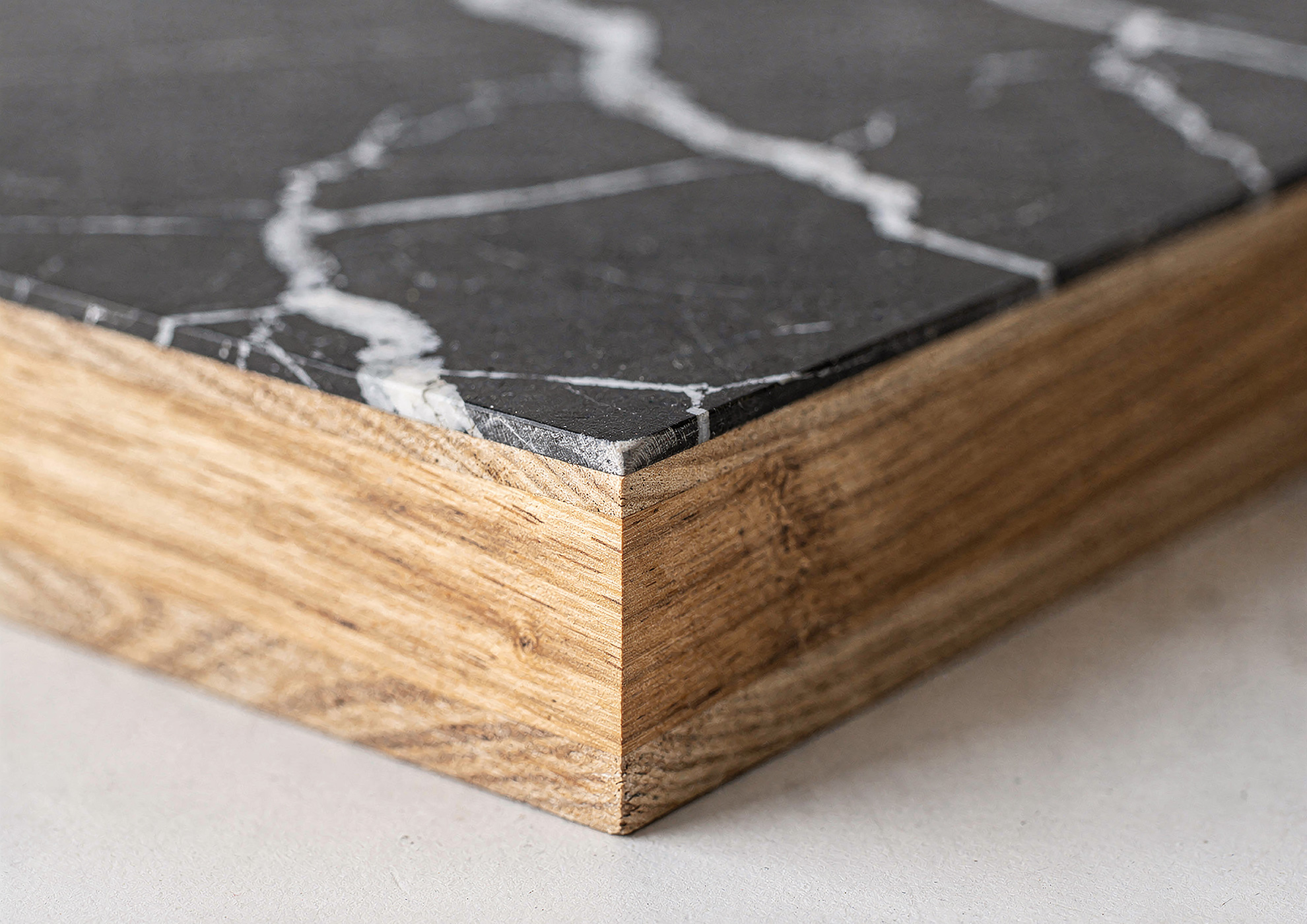STONAIR black marble edge detail applied on wood substrate.