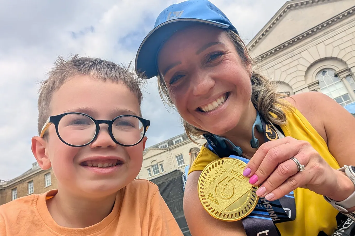 Mother and son celebrating mother's London marathon medal