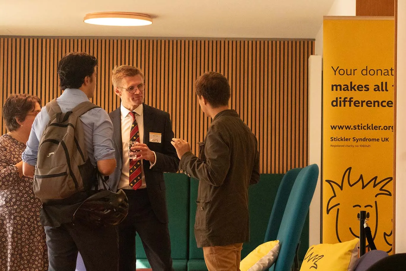 Consultant Plastic & Cleft Surgeon, Matt Fell, in discussion with delegates at the 2024 Stickler Syndrome Conference.