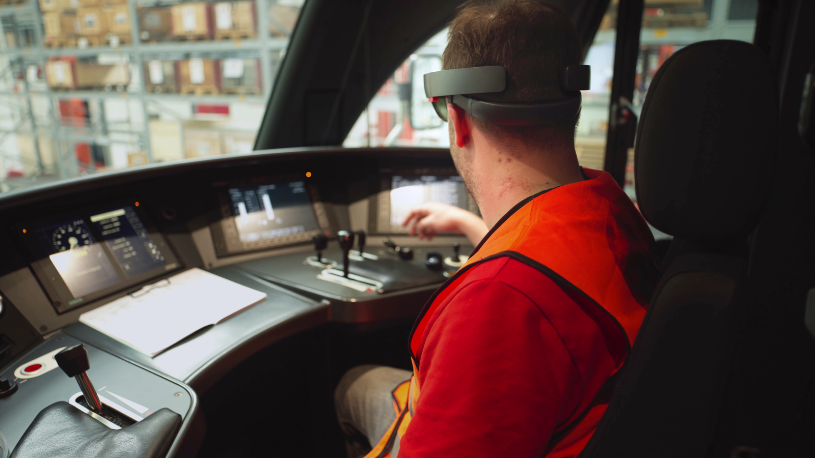 A train driver from SBB wearing an augmented reality headset in the train cockpit.