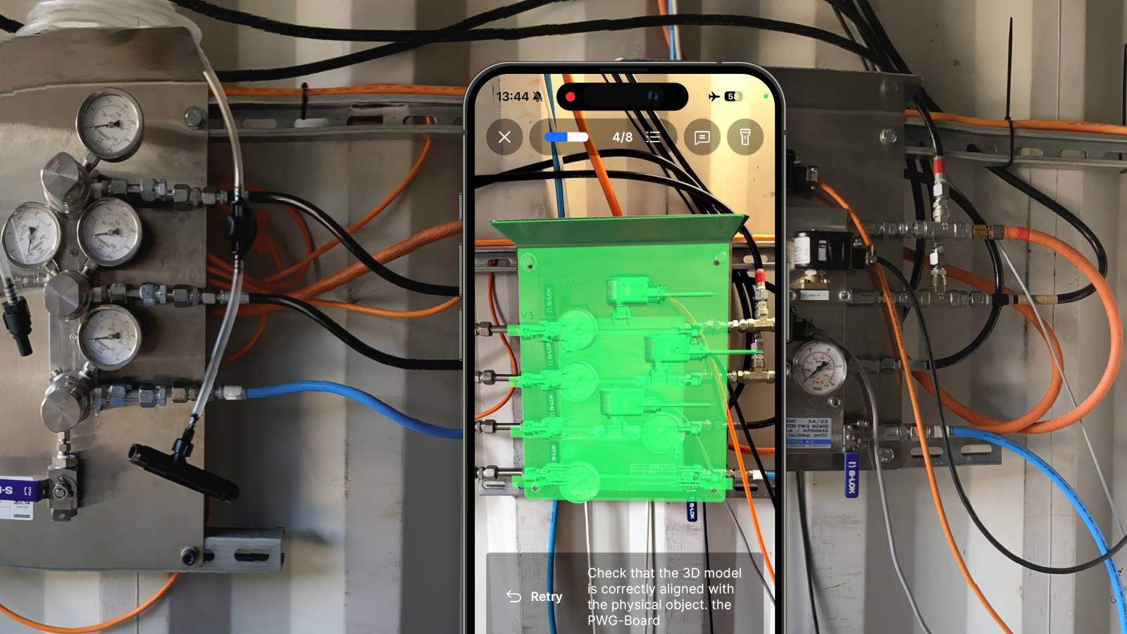Person using a smartphone to view an augmented reality overlay on a valve board from P-Wave Manufacturer.