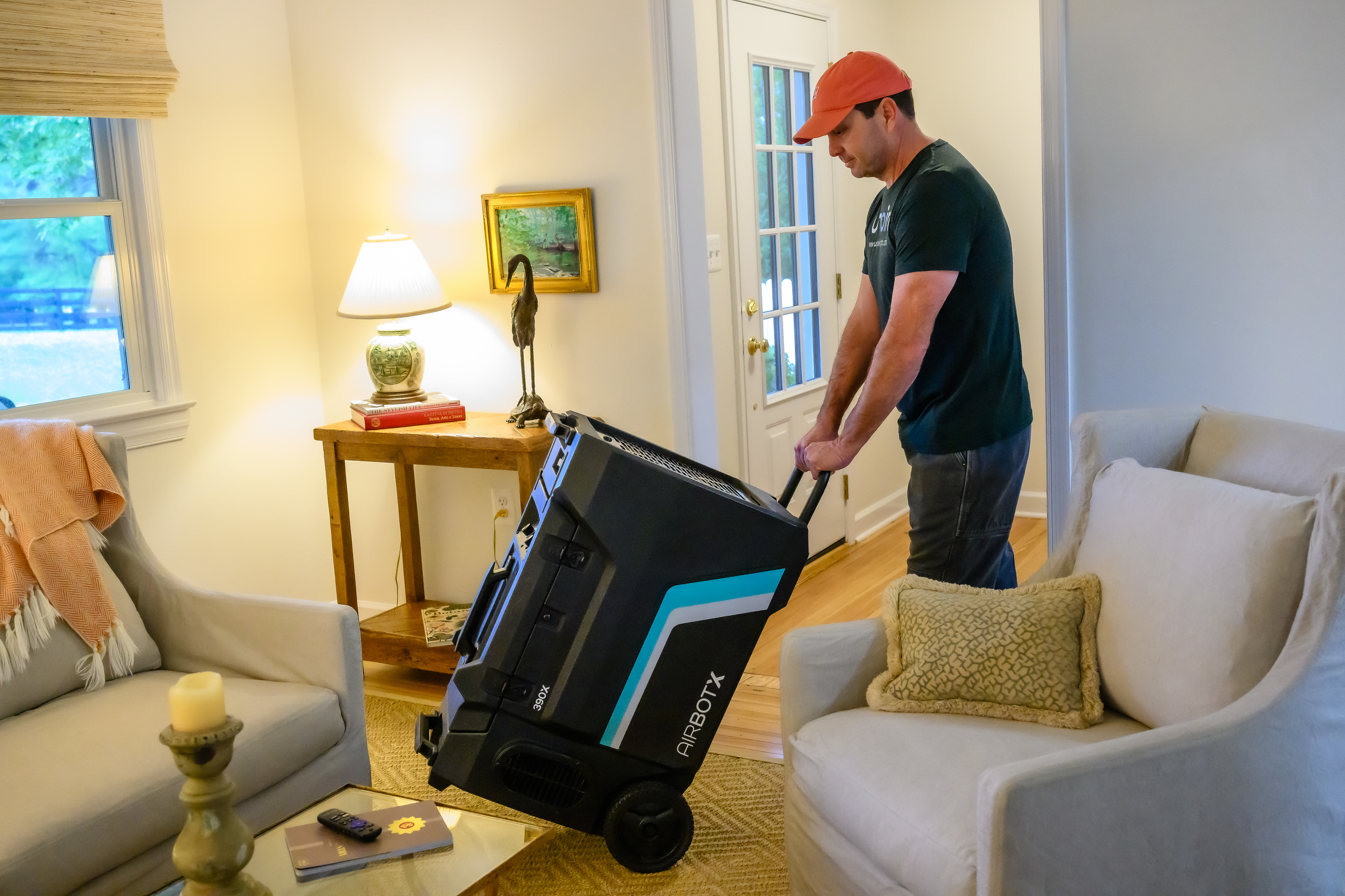 Umpire Mitigation technician using an air scrubber for odor removal and disinfection