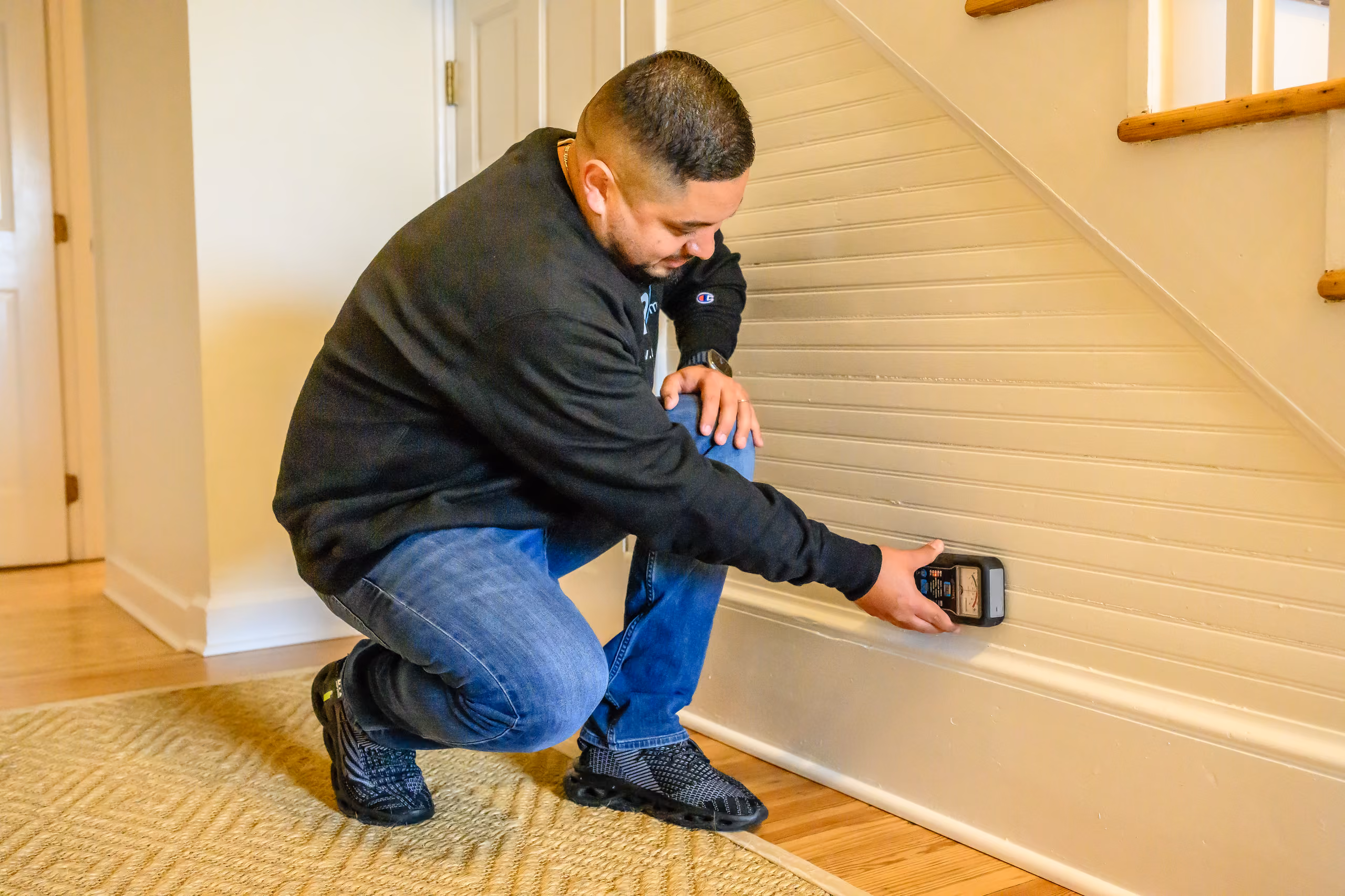 Umpire Mitigation technician performing a moisture check for mold