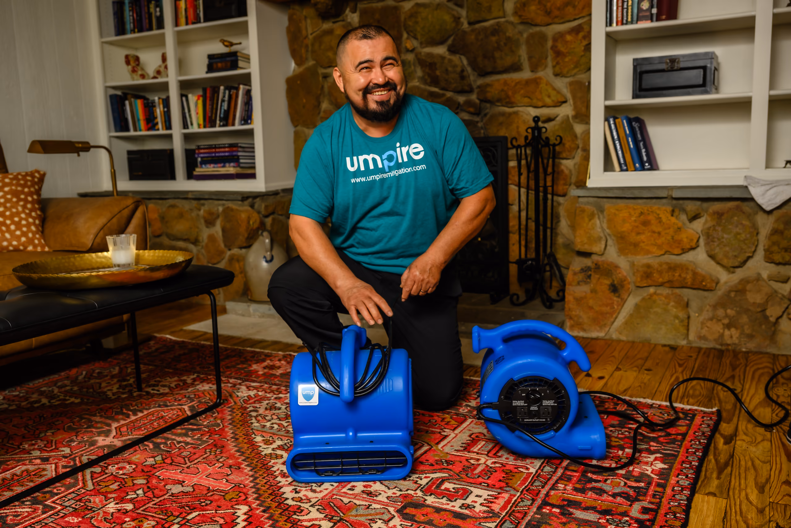 Umpire Mitigation technician smiling after completing a water damage cleanup