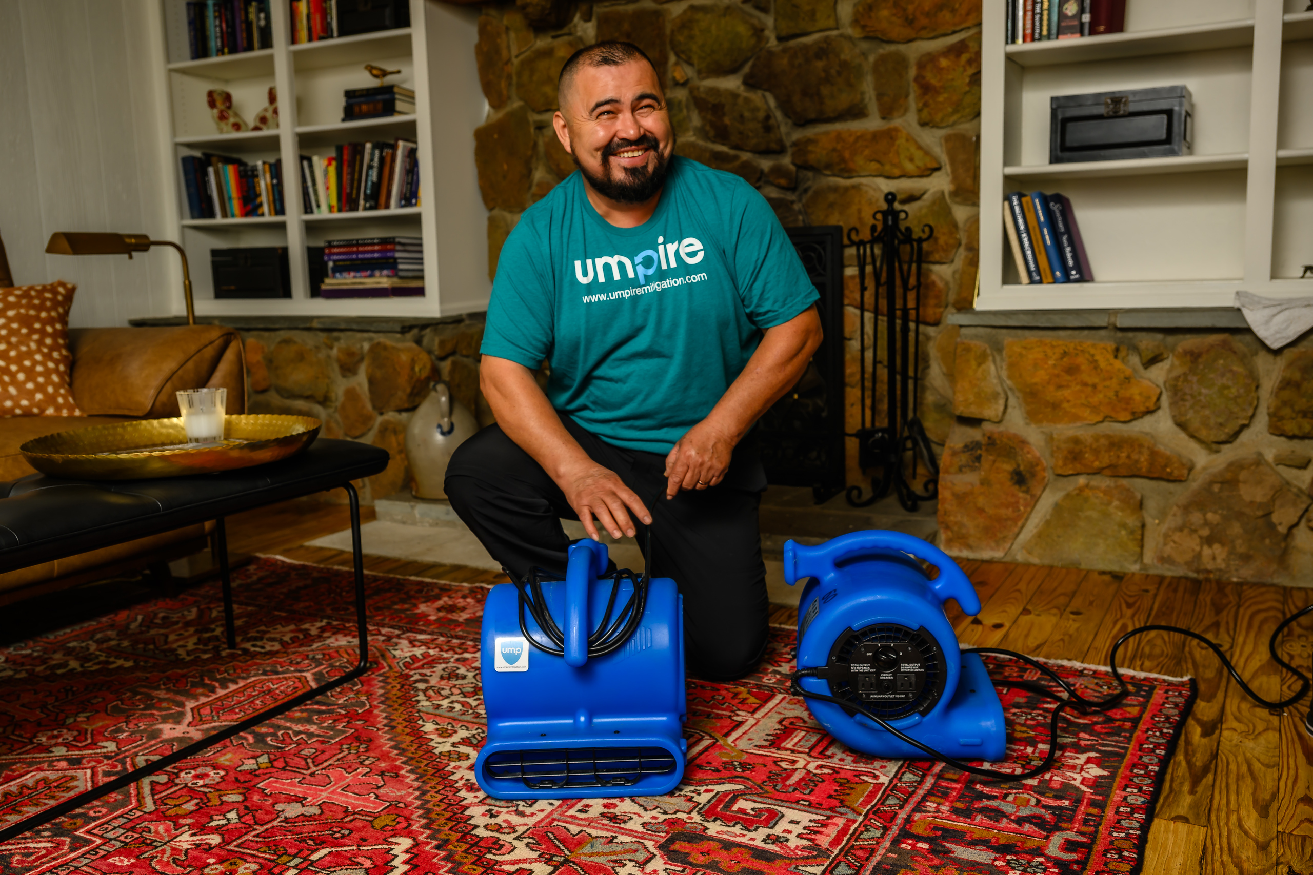 Umpire Mitigation technician smiling after completing a water damage cleanup