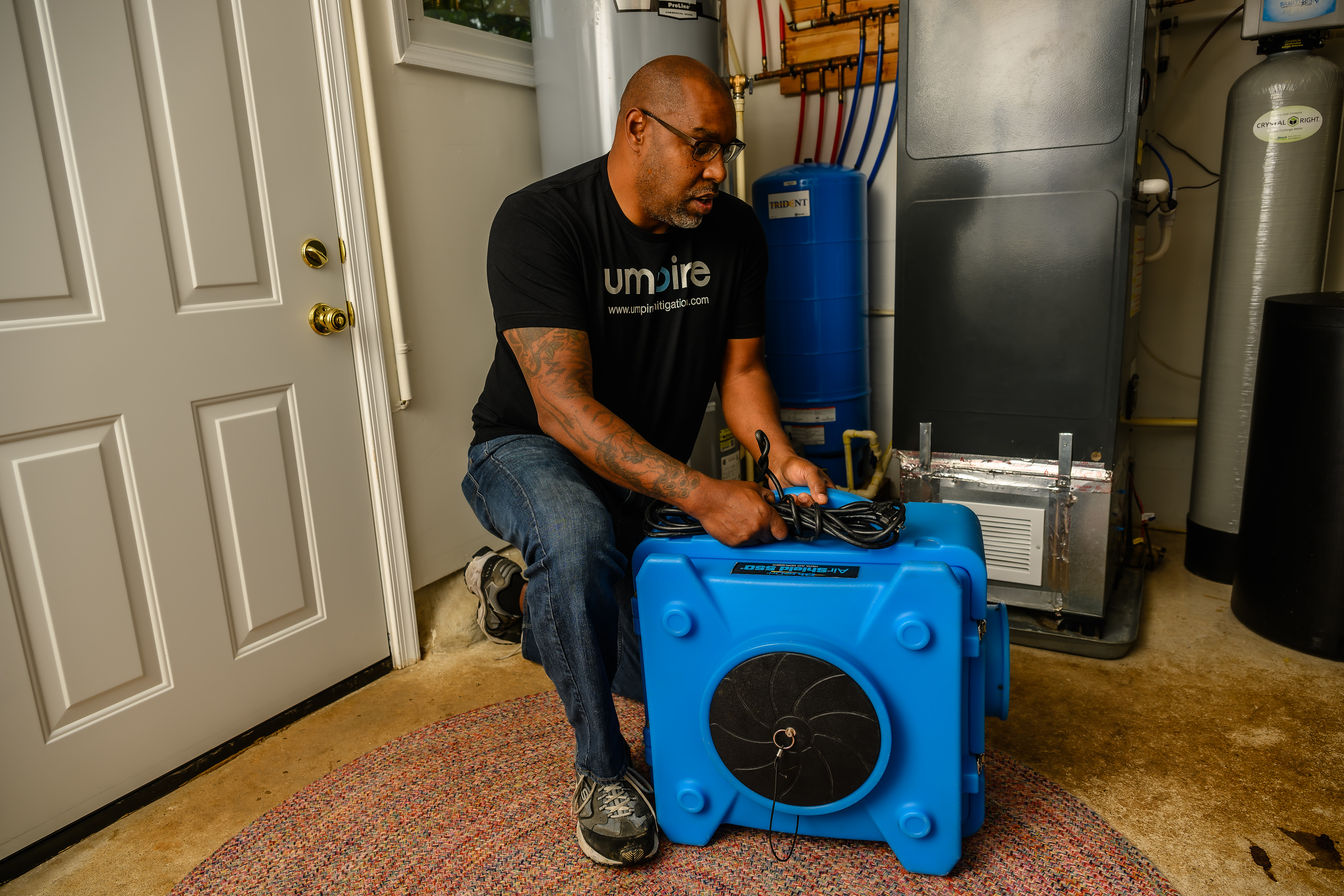 Trey Robinson operating an air scrubber during a Front Royal restoration job