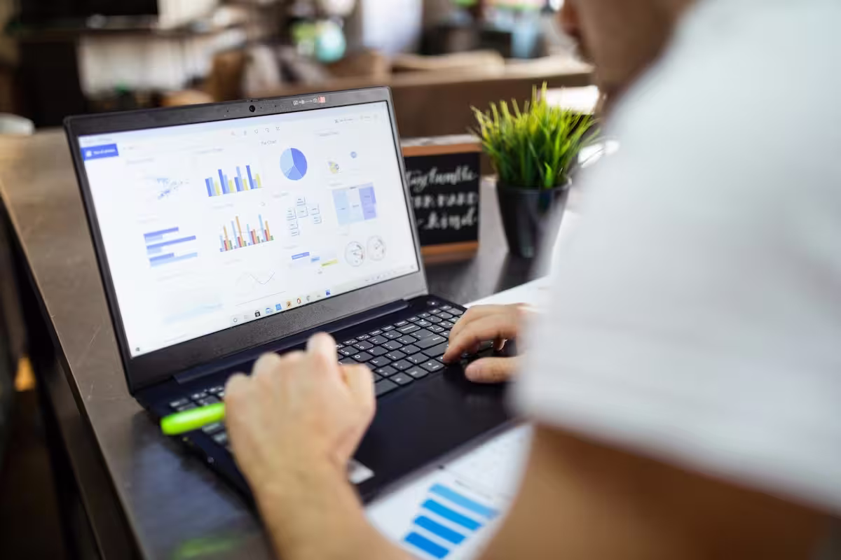 Person reviewing spend analytics dashboards on a laptop, illustrating Carta's customer story with Tropic
