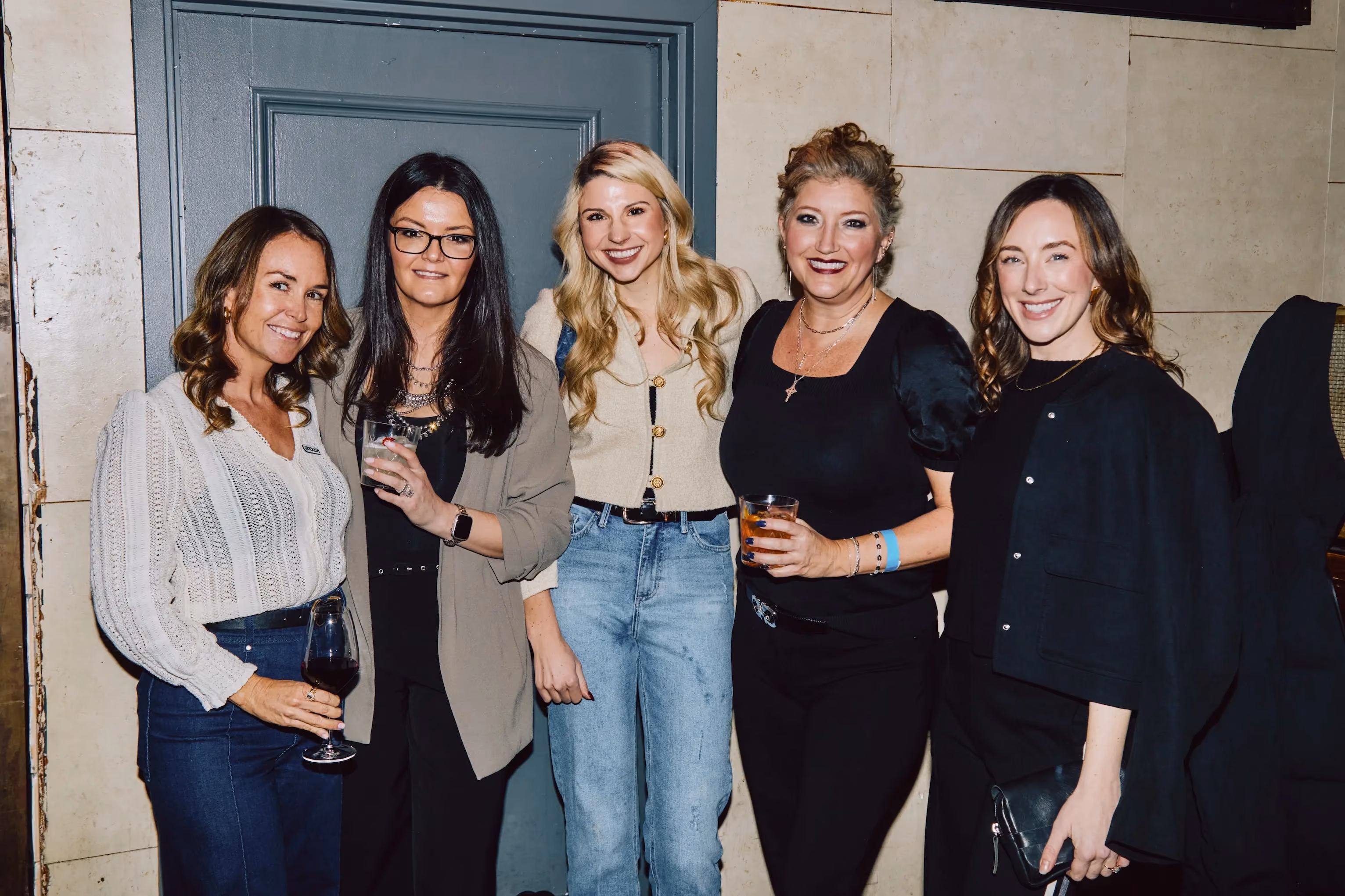 Five colleagues posing together and smiling at an ehouse team party.