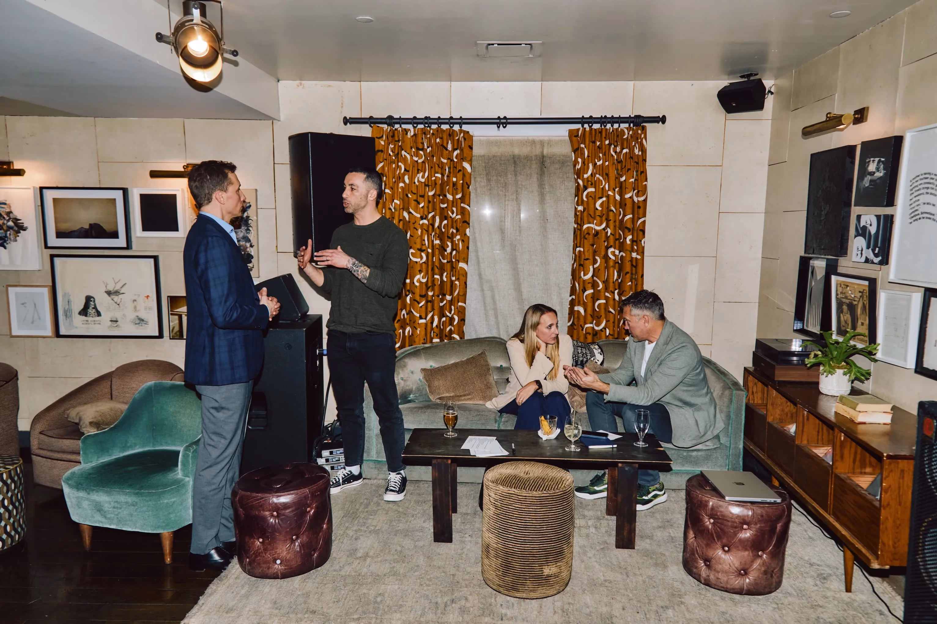 Colleagues talking and seated in a lounge area at an ehouse team event.