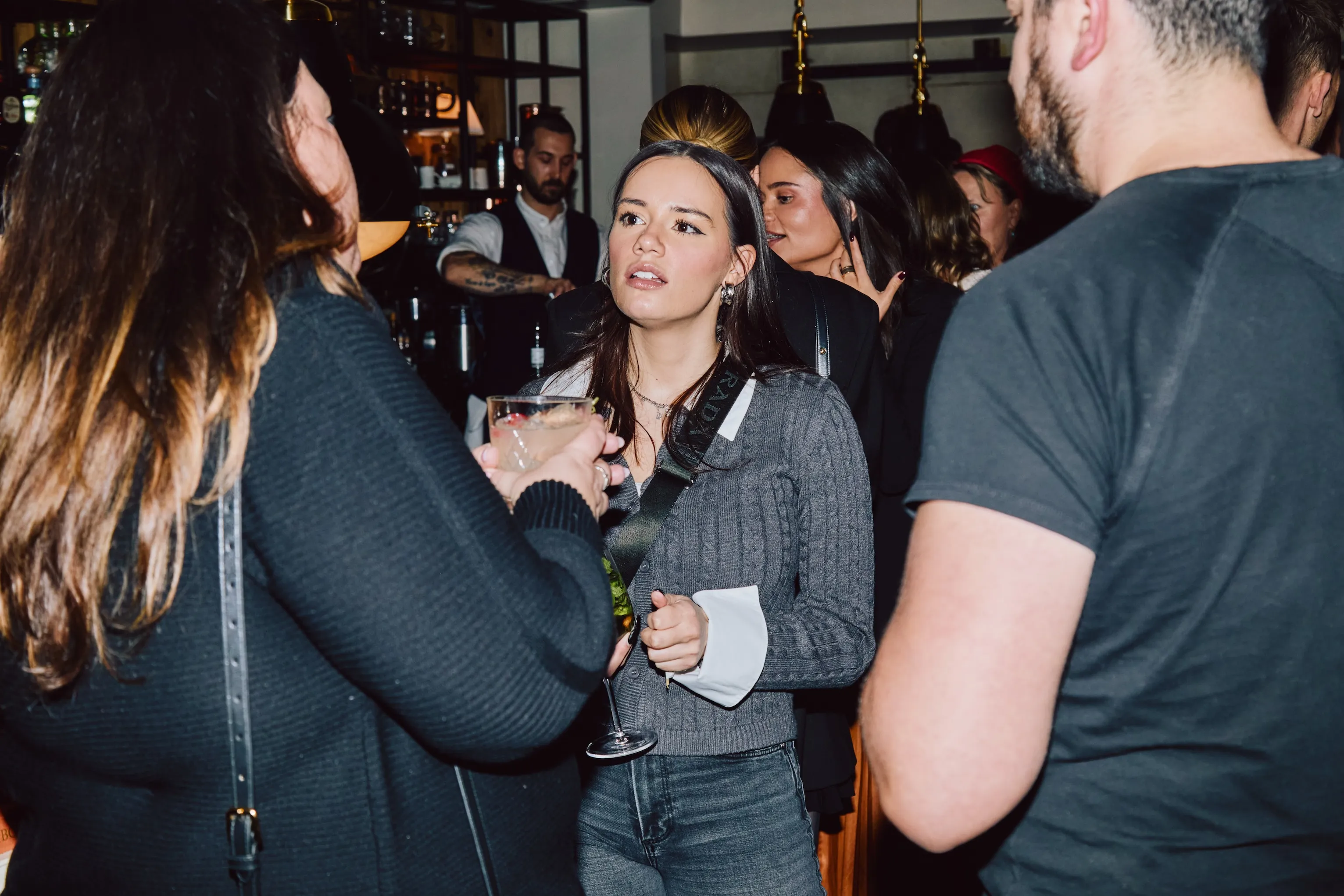 Colleagues mingling with drinks at an ehouse team party.