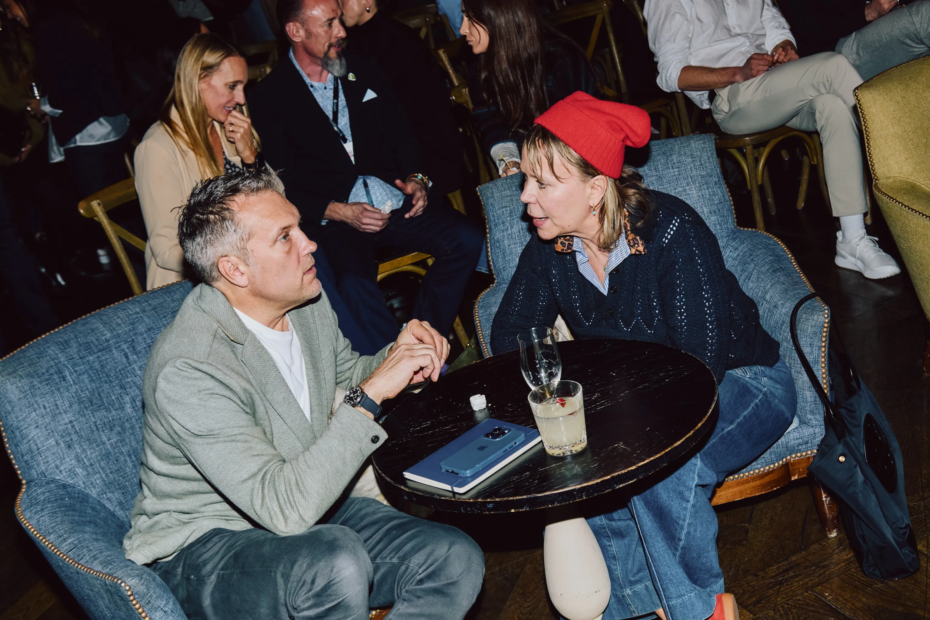Two colleagues in conversation at a table during an ehouse team event.