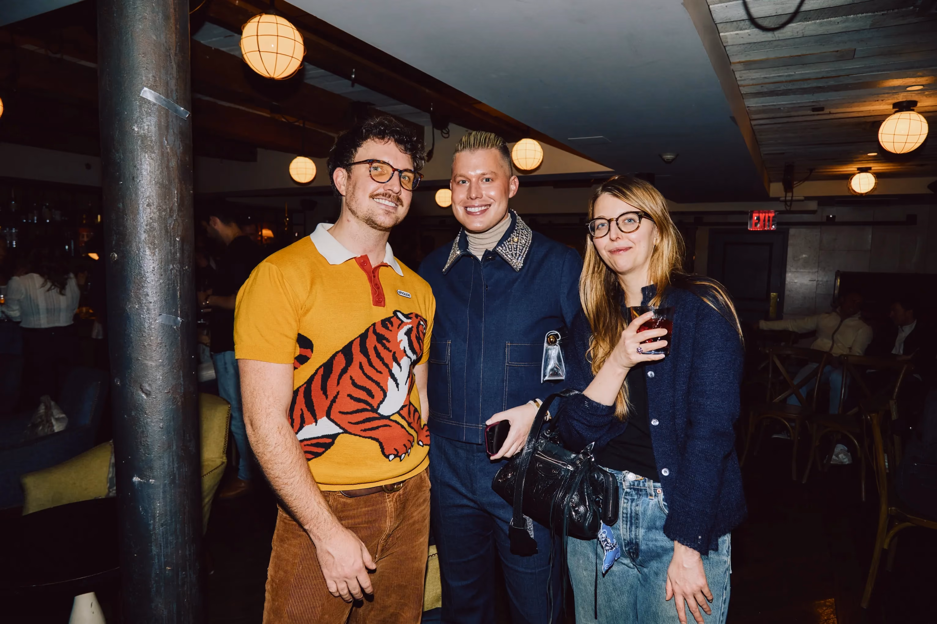 Three colleagues smiling together at an ehouse team party.